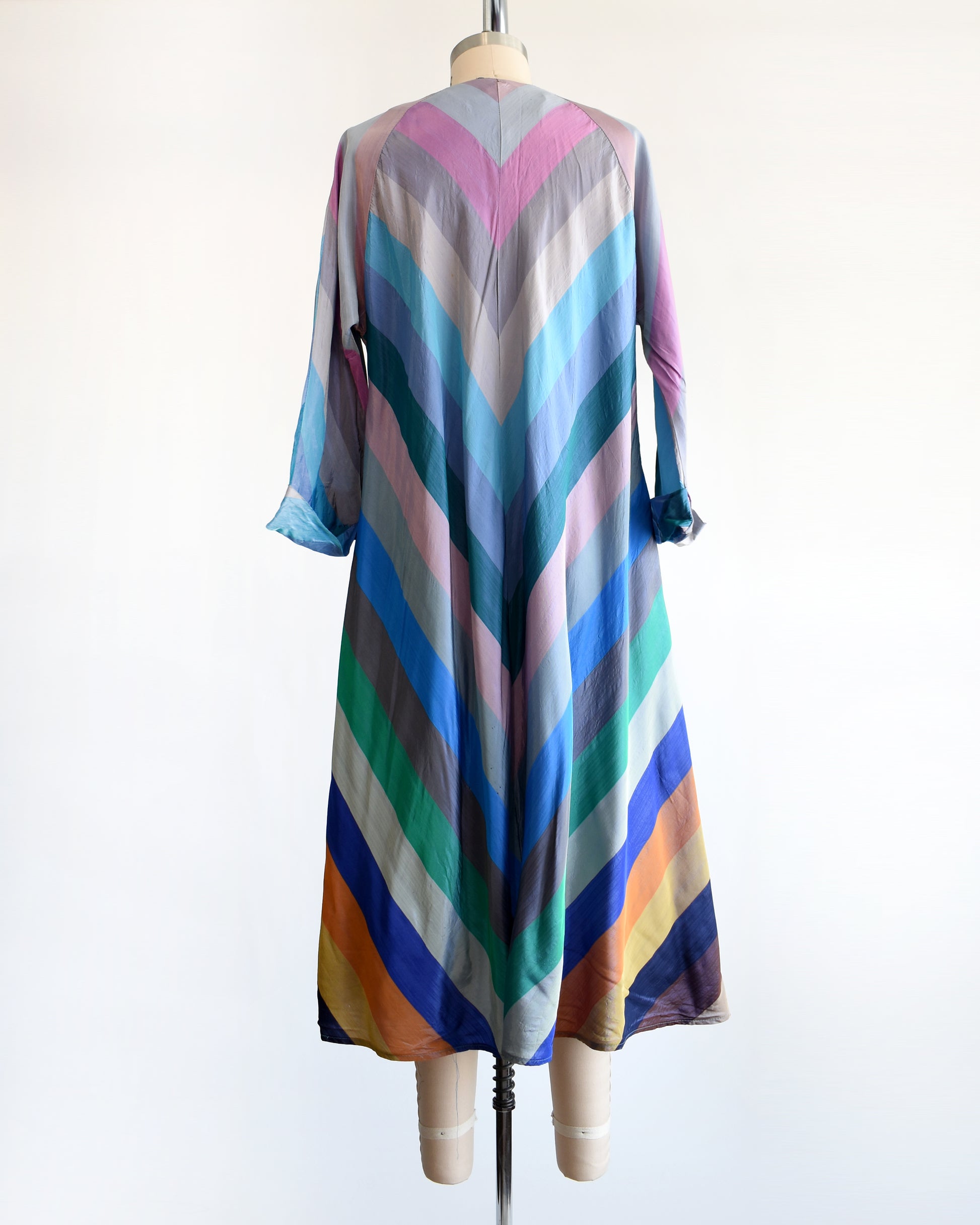 back view of a vintage 1940s multicolored striped dress  robe on a mannequin against a white background