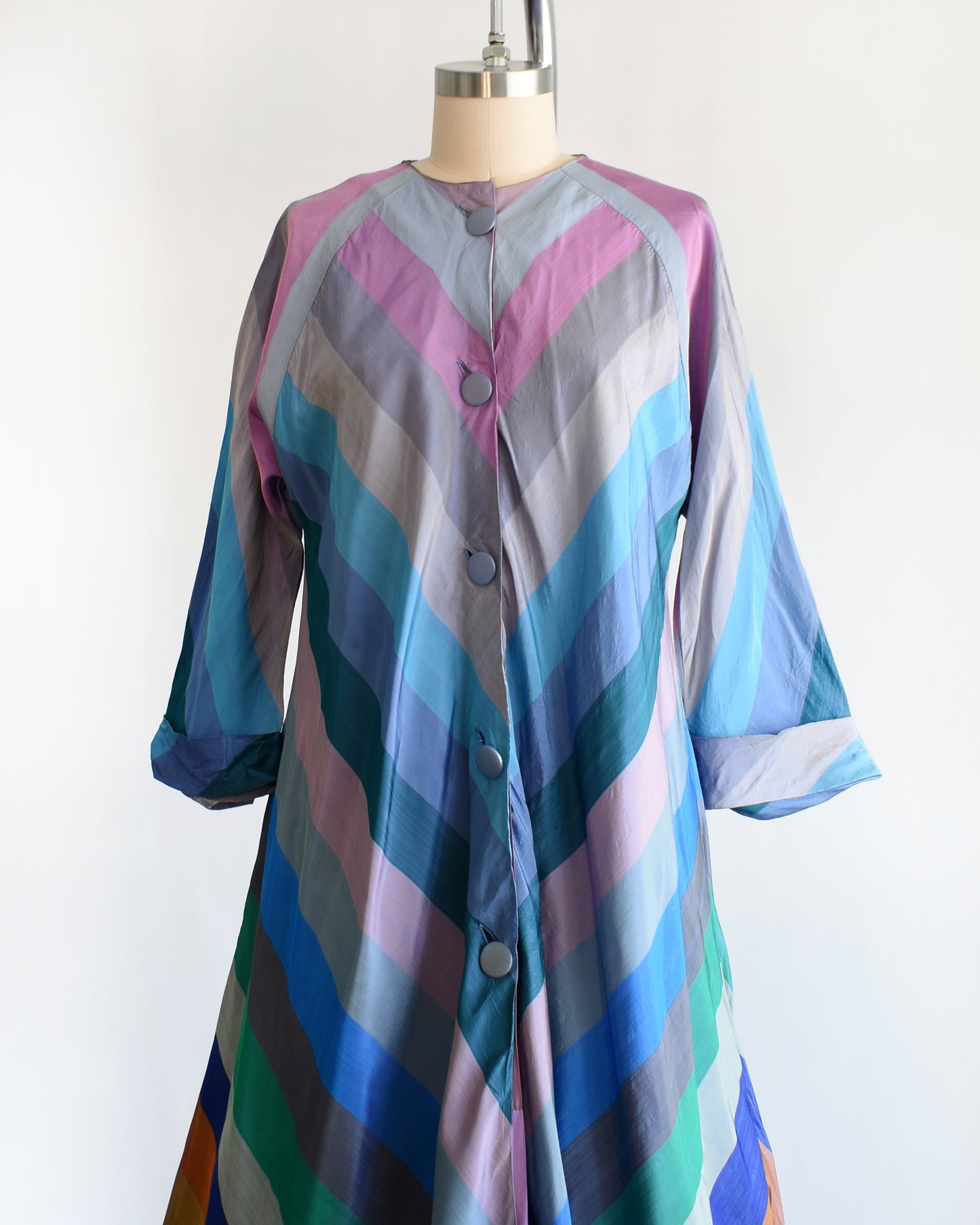 side front view of a vintage 1940s multicolored striped dress  robe on a mannequin against a white background