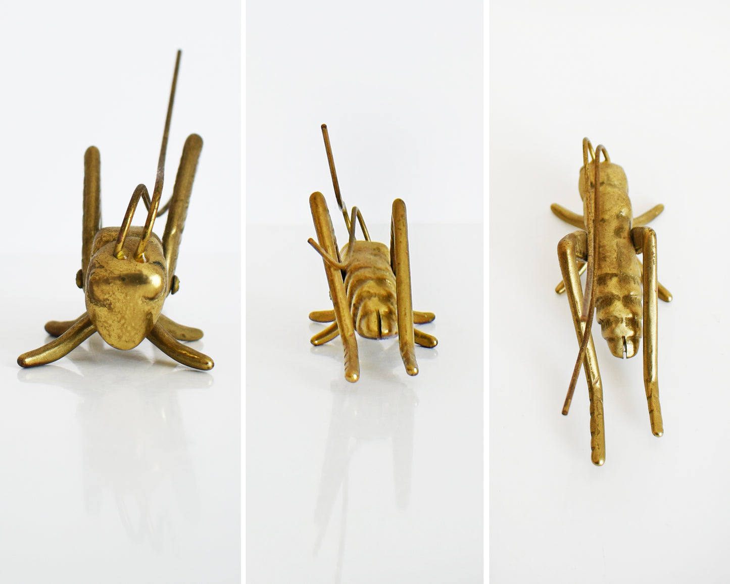 Side by side front and back of a vintage brass grasshopper/cricket on a white table.