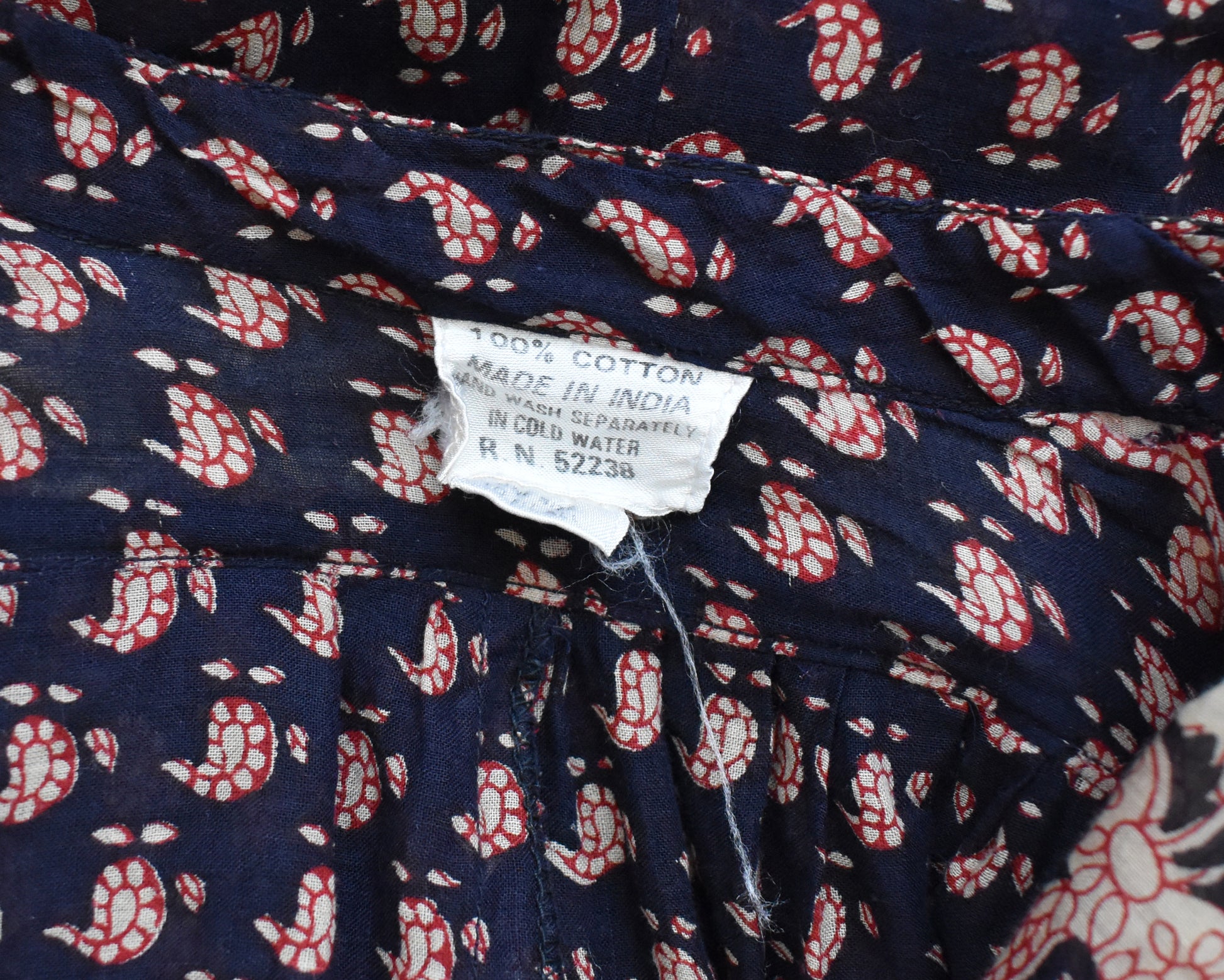 Close up of the tag that says 100% cotton, made in India