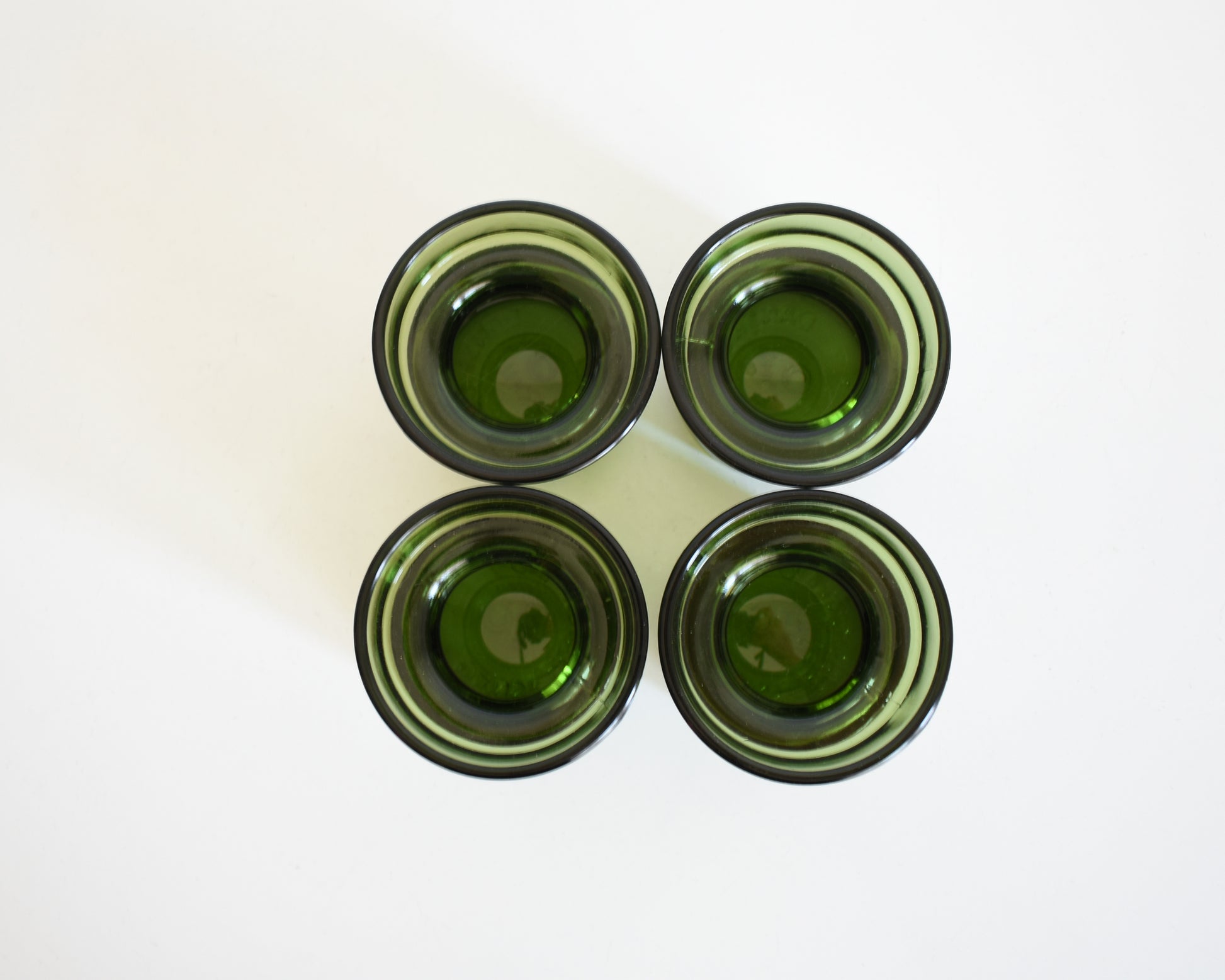 Set of four vintage 1960s green glass  Dansk candle holders viewed from the top