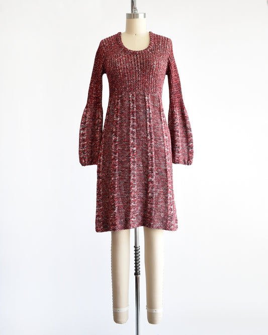 a vintage 1970s burgundy space dye long-sleeve dress displayed on a cream dress form mannequin against a plain white background.