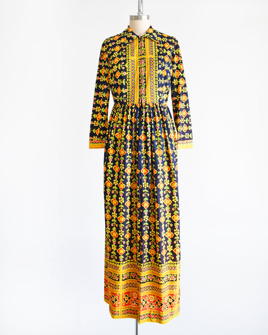 A vintage 1970s navy blue maxi dress with a colorful striped floral print.