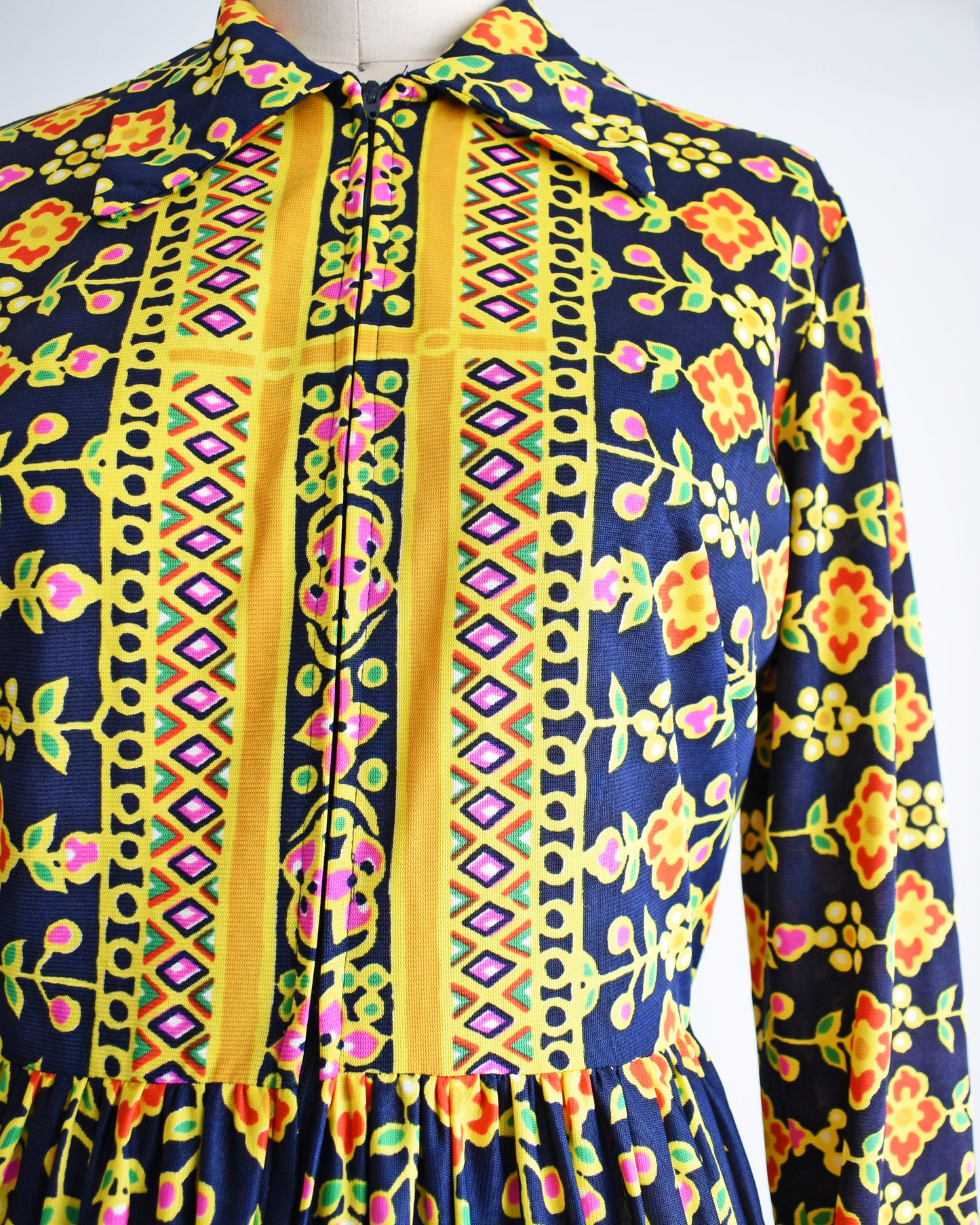 Close up of the bodice of the dress which shows the striped floral print and geometric shapes