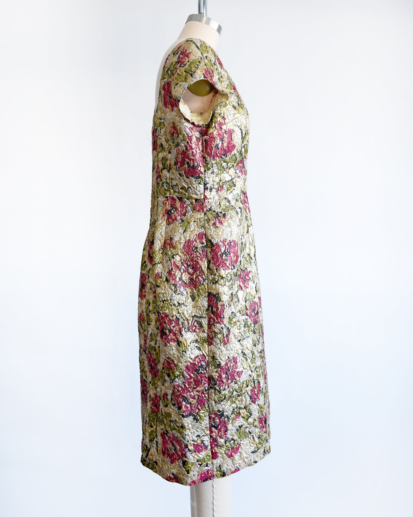 side view of a vintage 1960s floral metallic brocade dress.