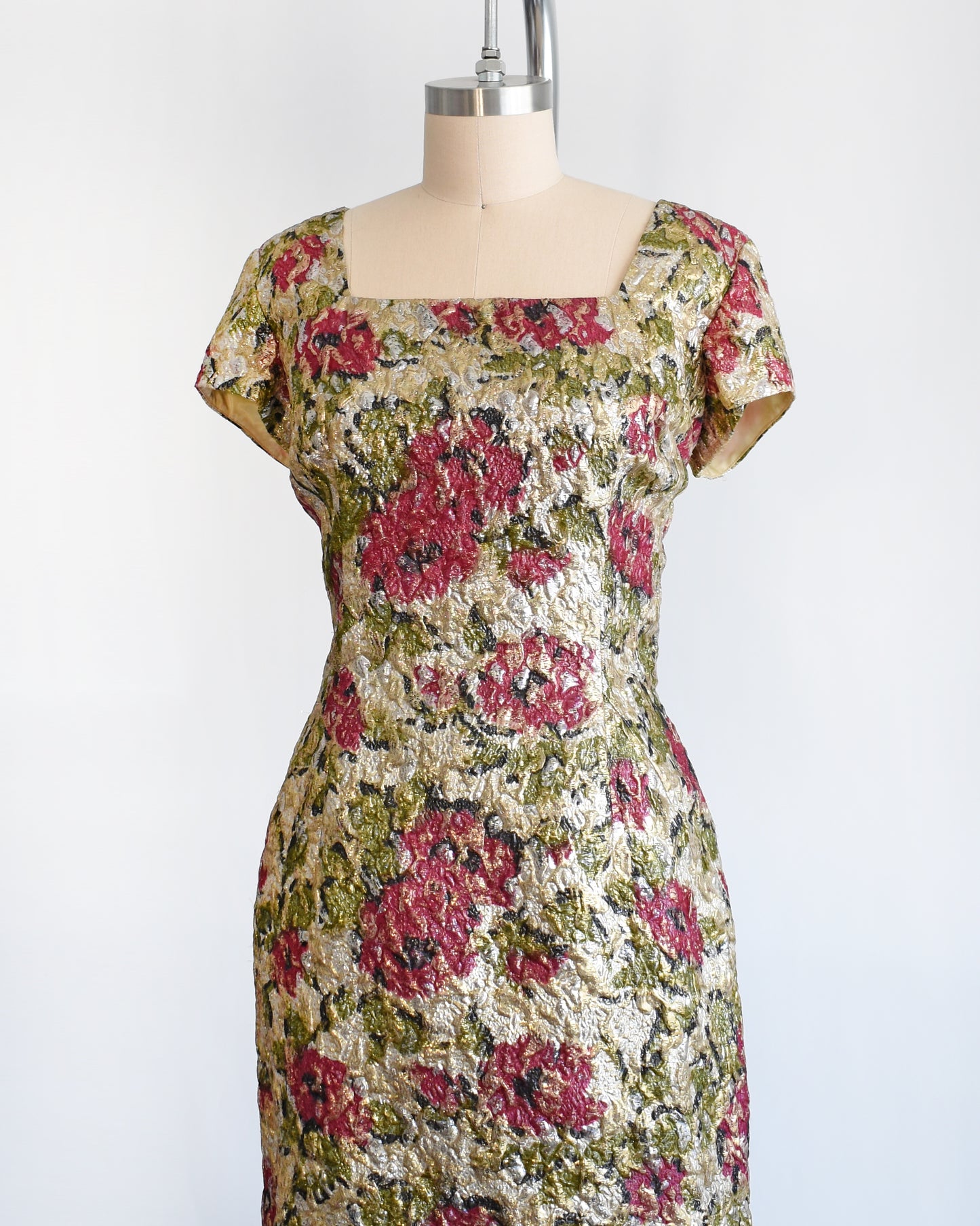 side front view of a vintage 1960s floral metallic brocade dress.