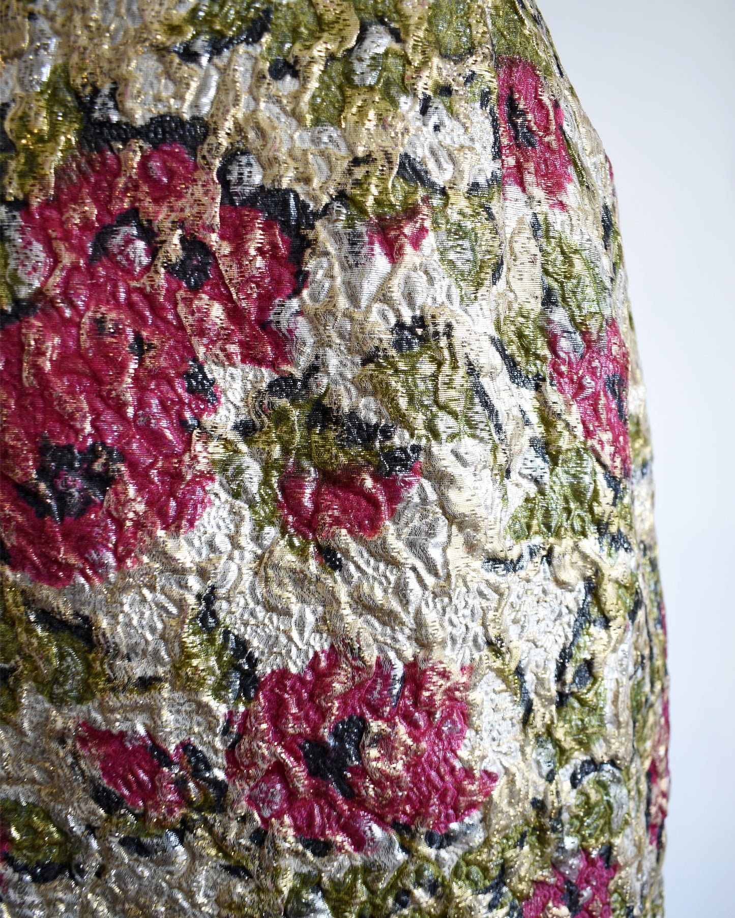 close up of a vintage 1960s floral metallic brocade dress.