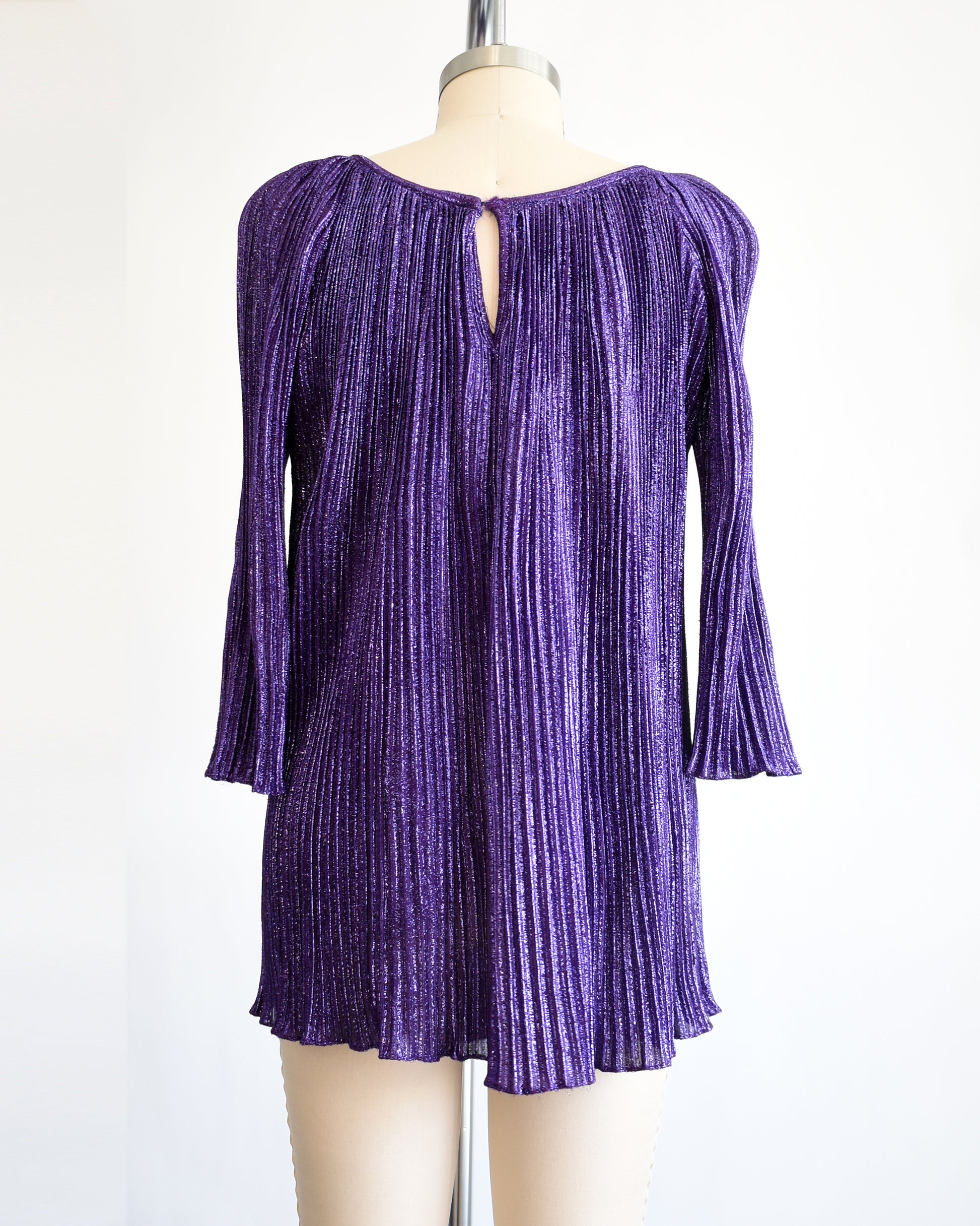 back view of a vintage 1960s metallic purple mini dress/tunic