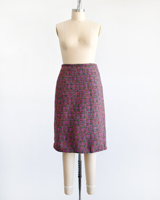 This 1960s vintage tweed skirt showcases multi-colored woven wool, displaying a palette of bright pink, purple, teal, brown, green and red hues