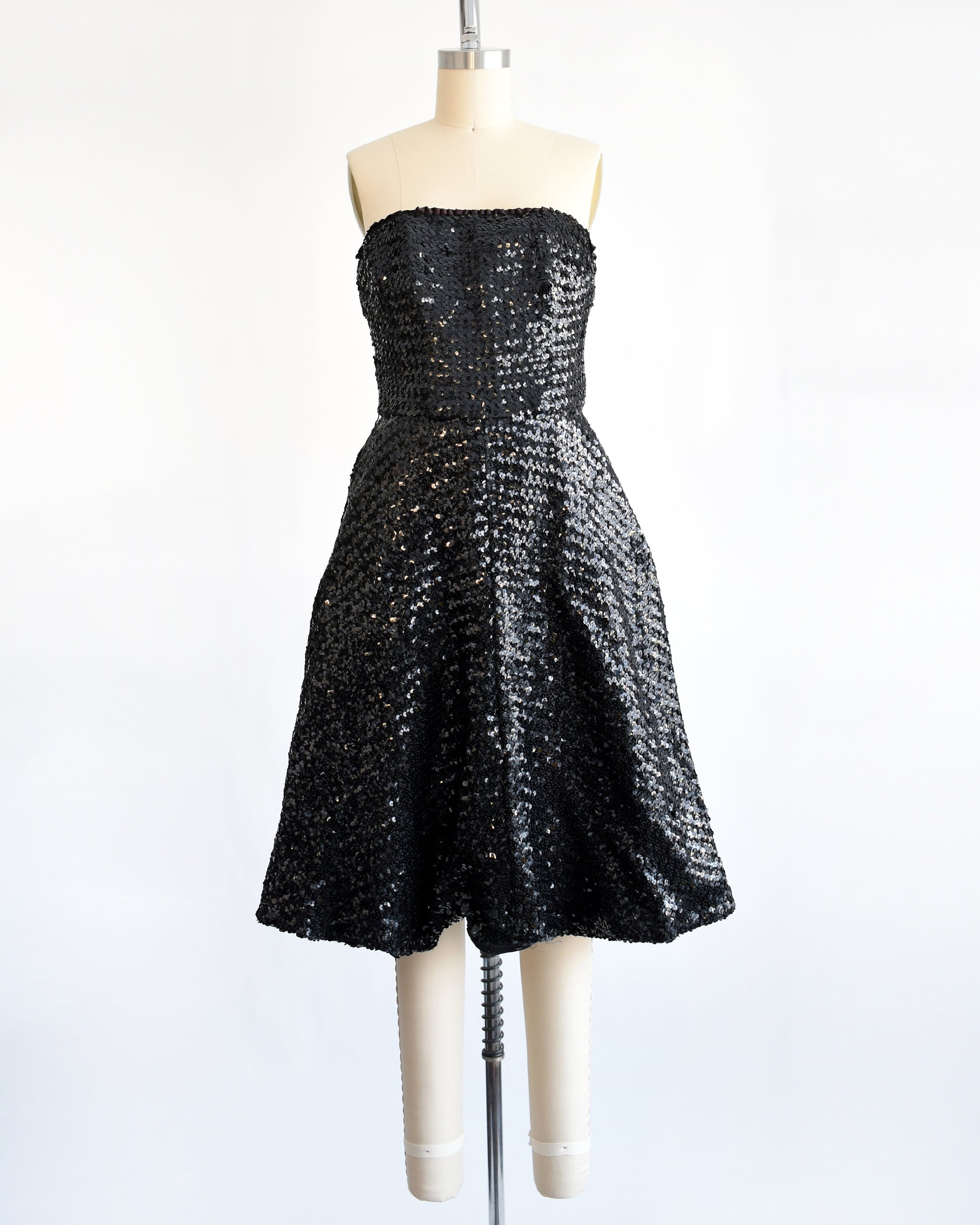 a vintage 1960s black sequin party dress