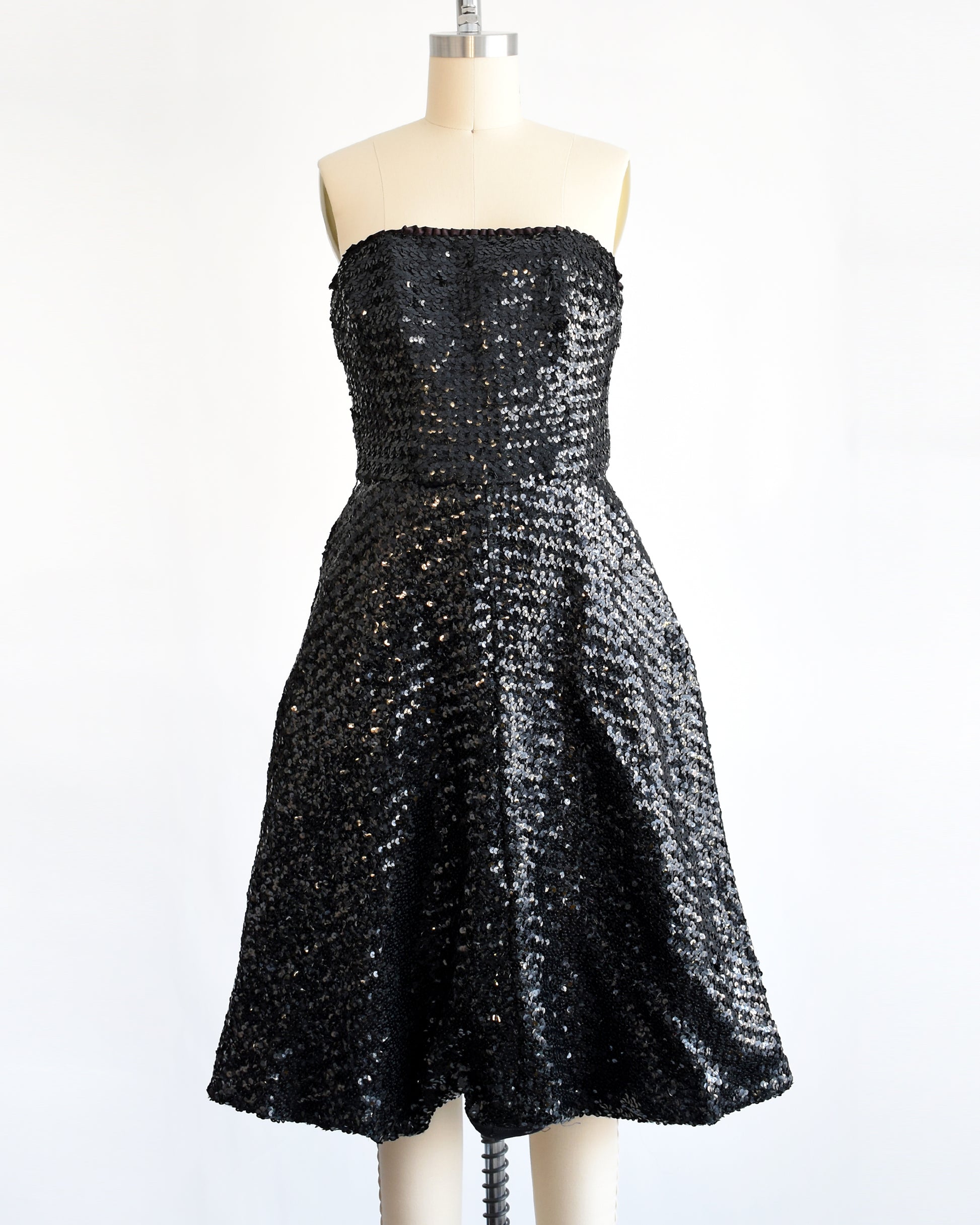 a vintage 1960s black sequin party dress