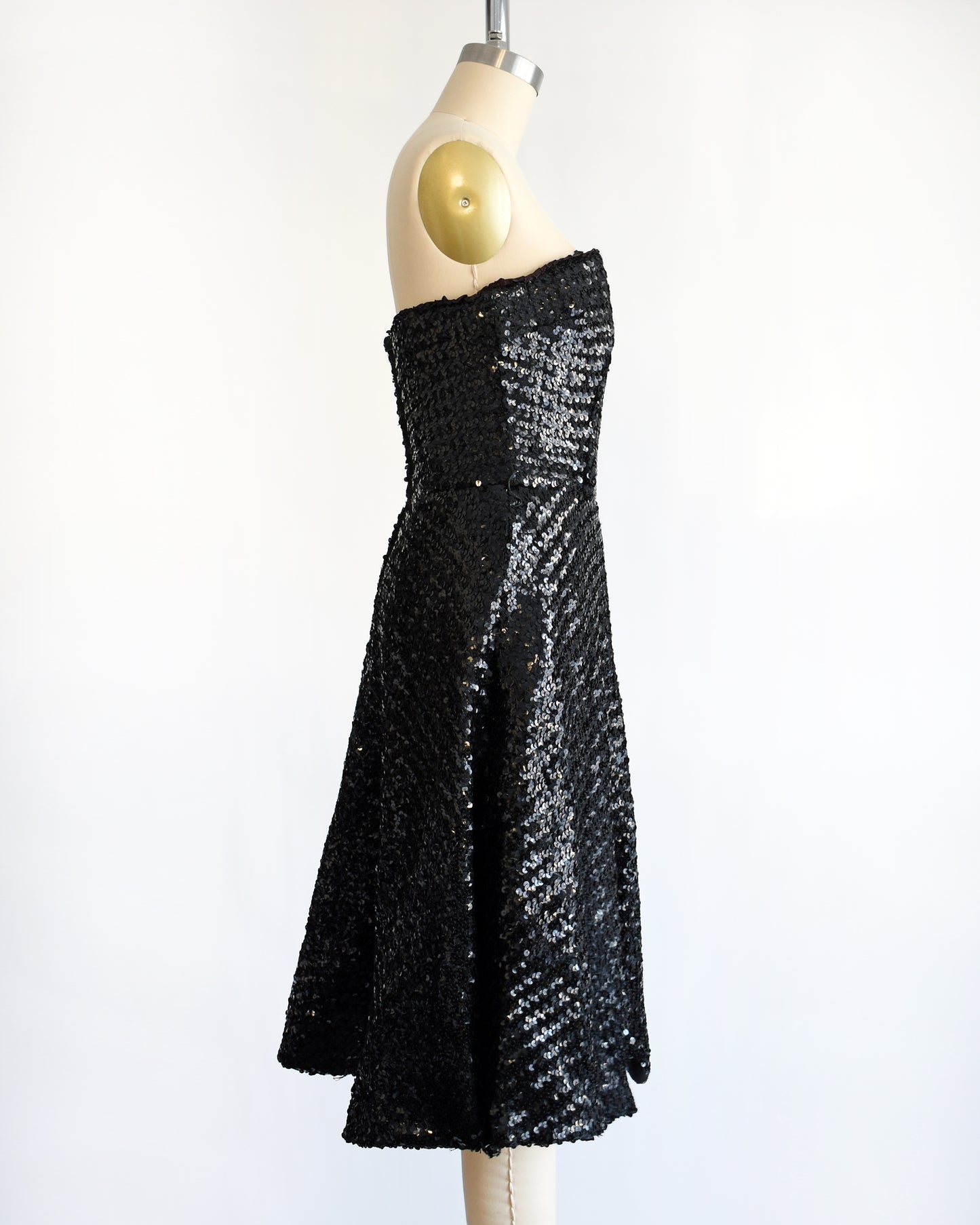 side view of a vintage 1960s black sequin party dress