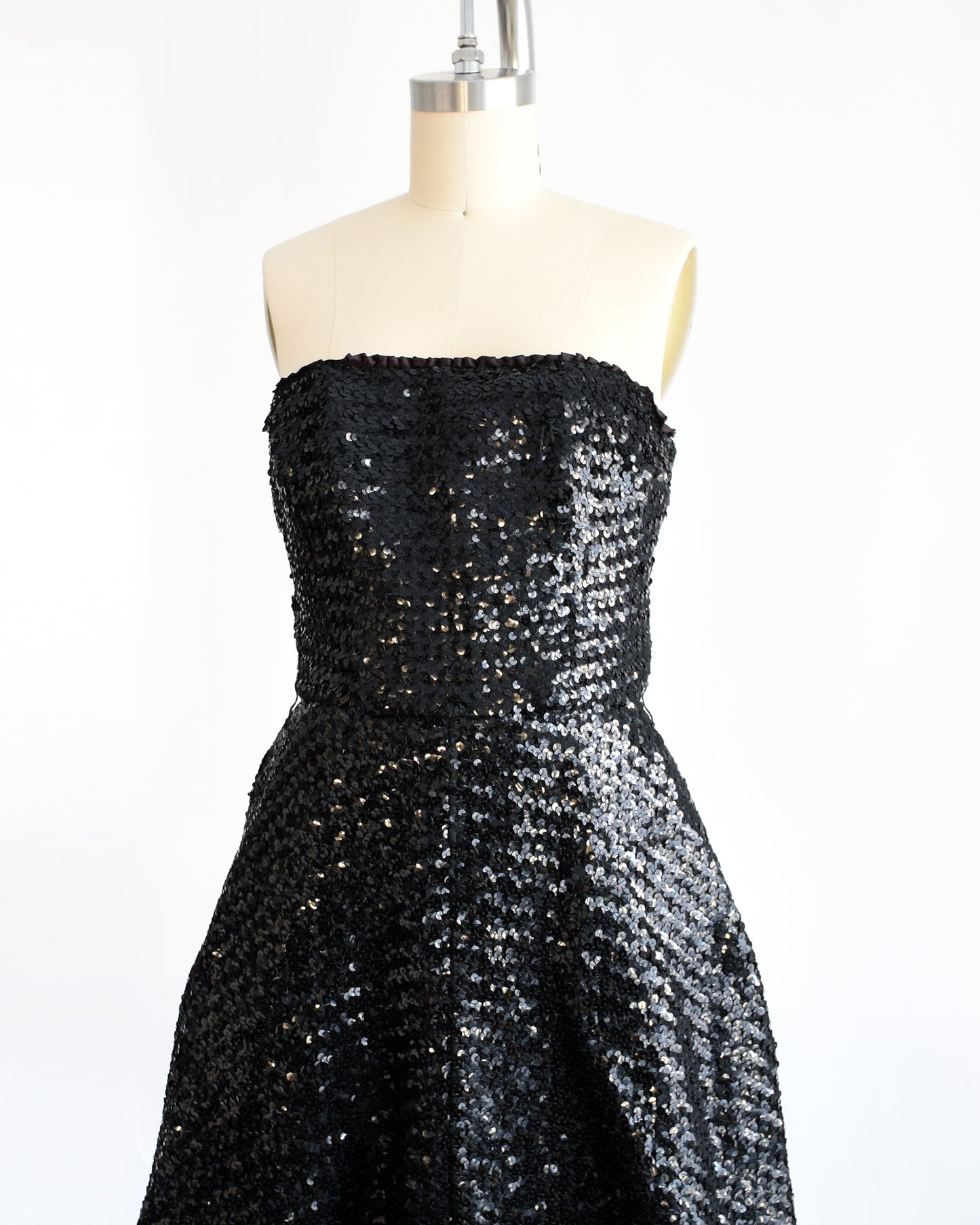 side front view of a vintage 1960s black sequin party dress