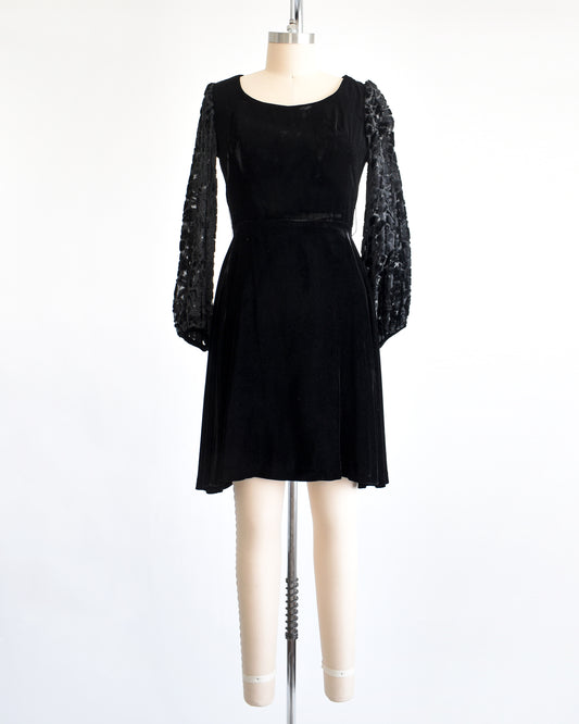 a vintage 1960s black velvet cocktail dress with black velvet burnout long sleeves