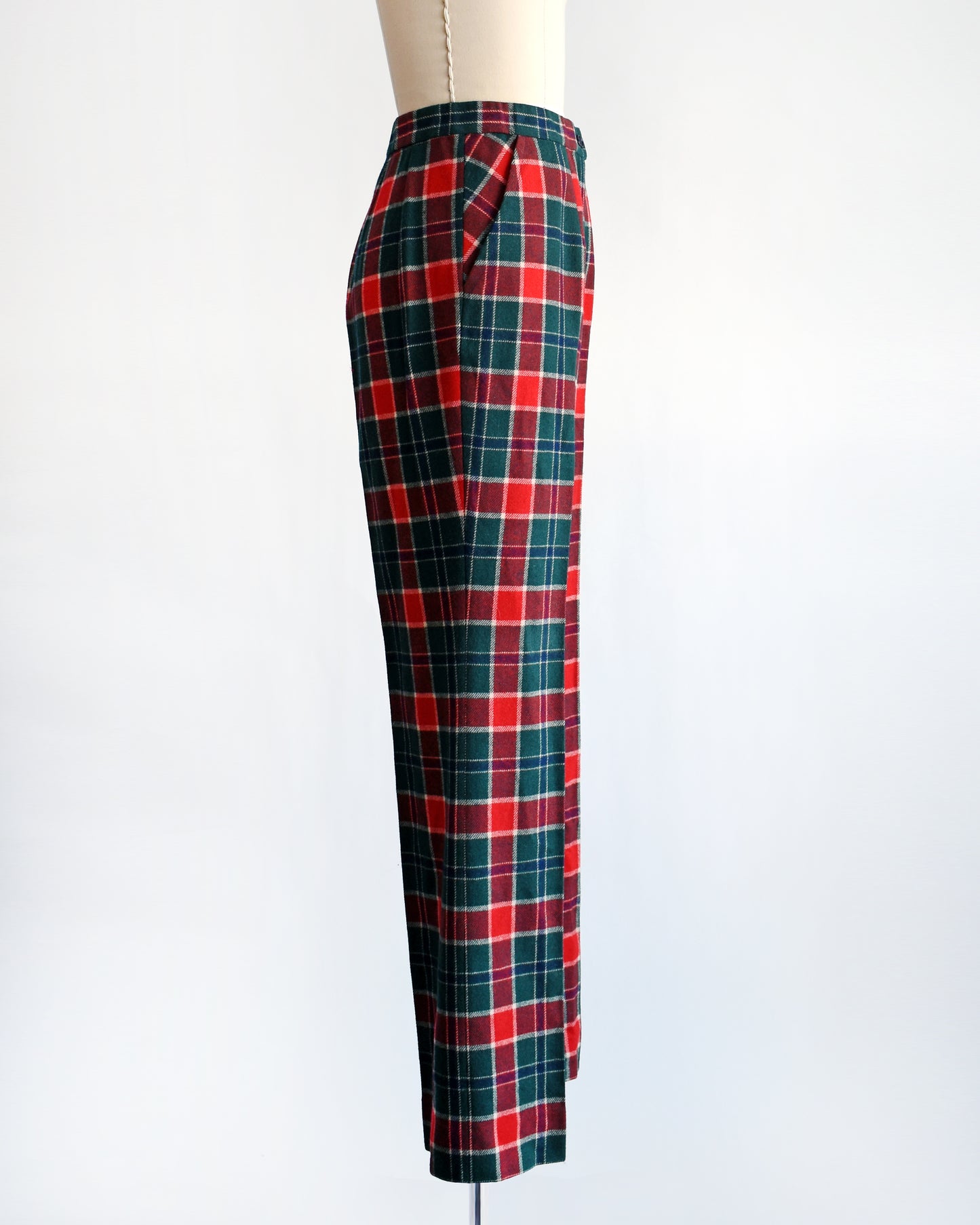 side view of a pair of vintage 1970s red, navy blue, green, and white plaid wool pants by Pendleton.