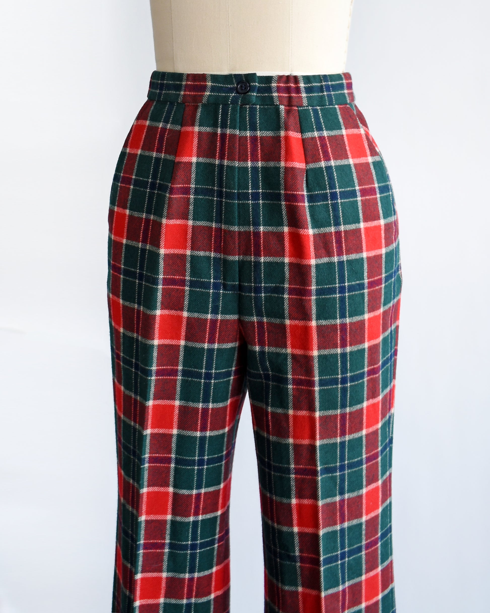 side front view of a pair of vintage 1970s red, navy blue, green, and white plaid wool pants by Pendleton.