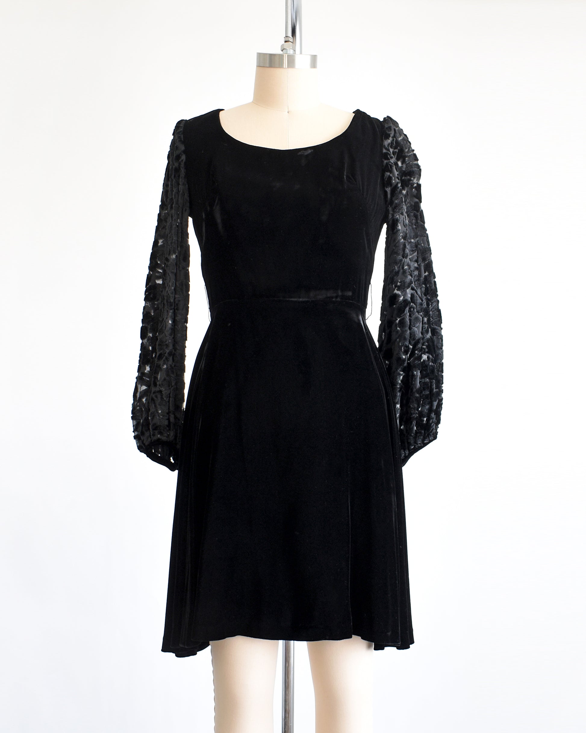 a vintage 1960s black velvet cocktail dress with black velvet burnout long sleeves