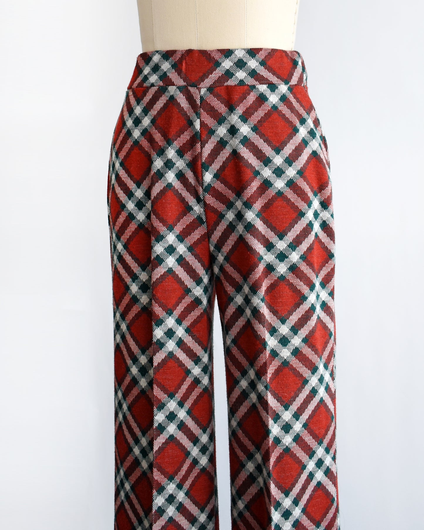 side front view of a pair of vintage 1970s red, green, and white plaid wide leg pants