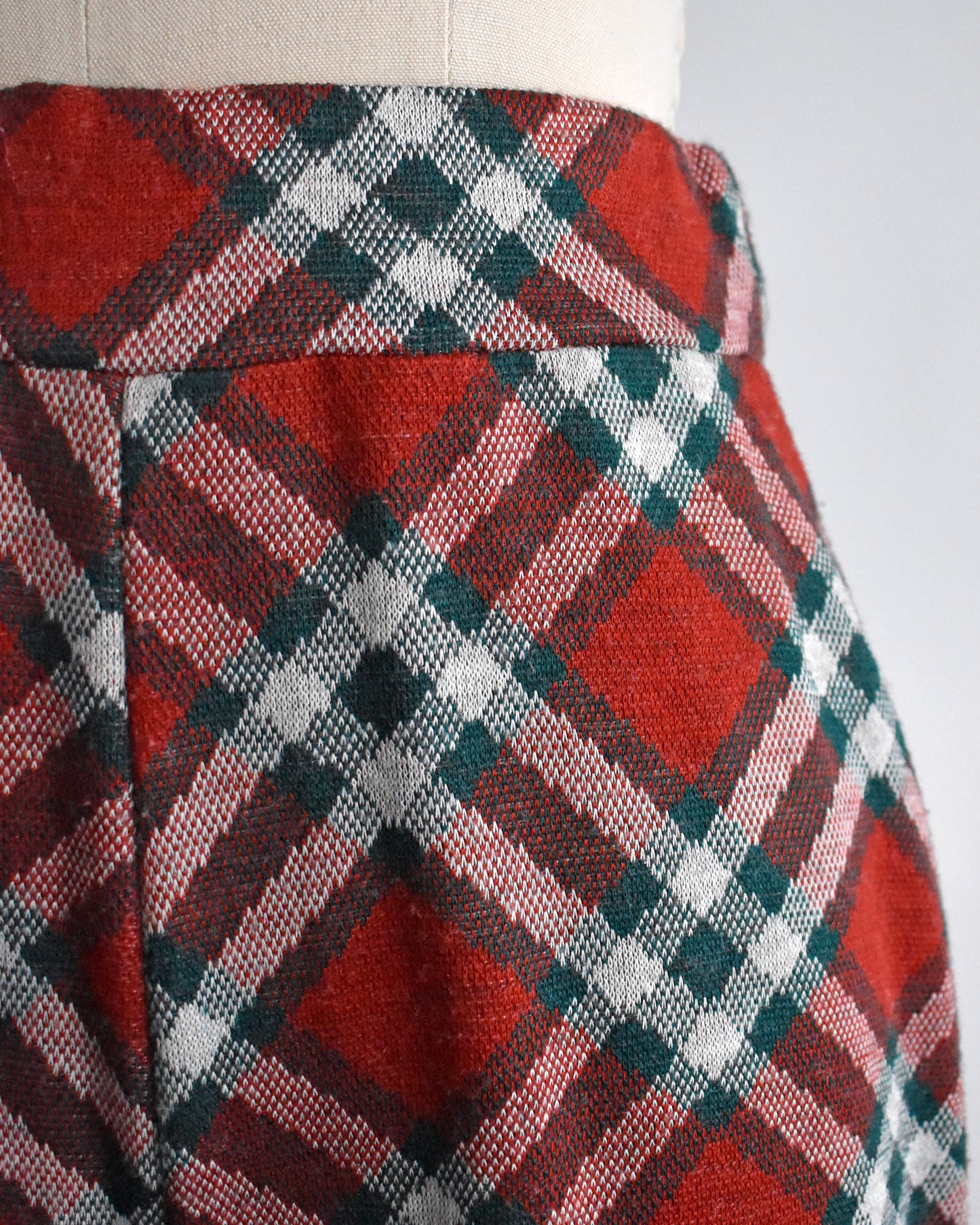 close up of the waist of a pair of vintage 1970s red, green, and white plaid wide leg pants