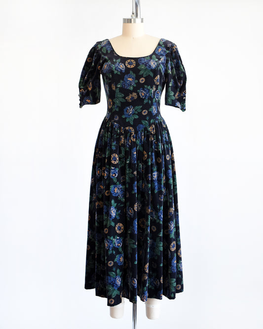 A vintage 1980s Laura Ashley dress. Black cotton velvet with a navy blue floral and metal gold jewels print.