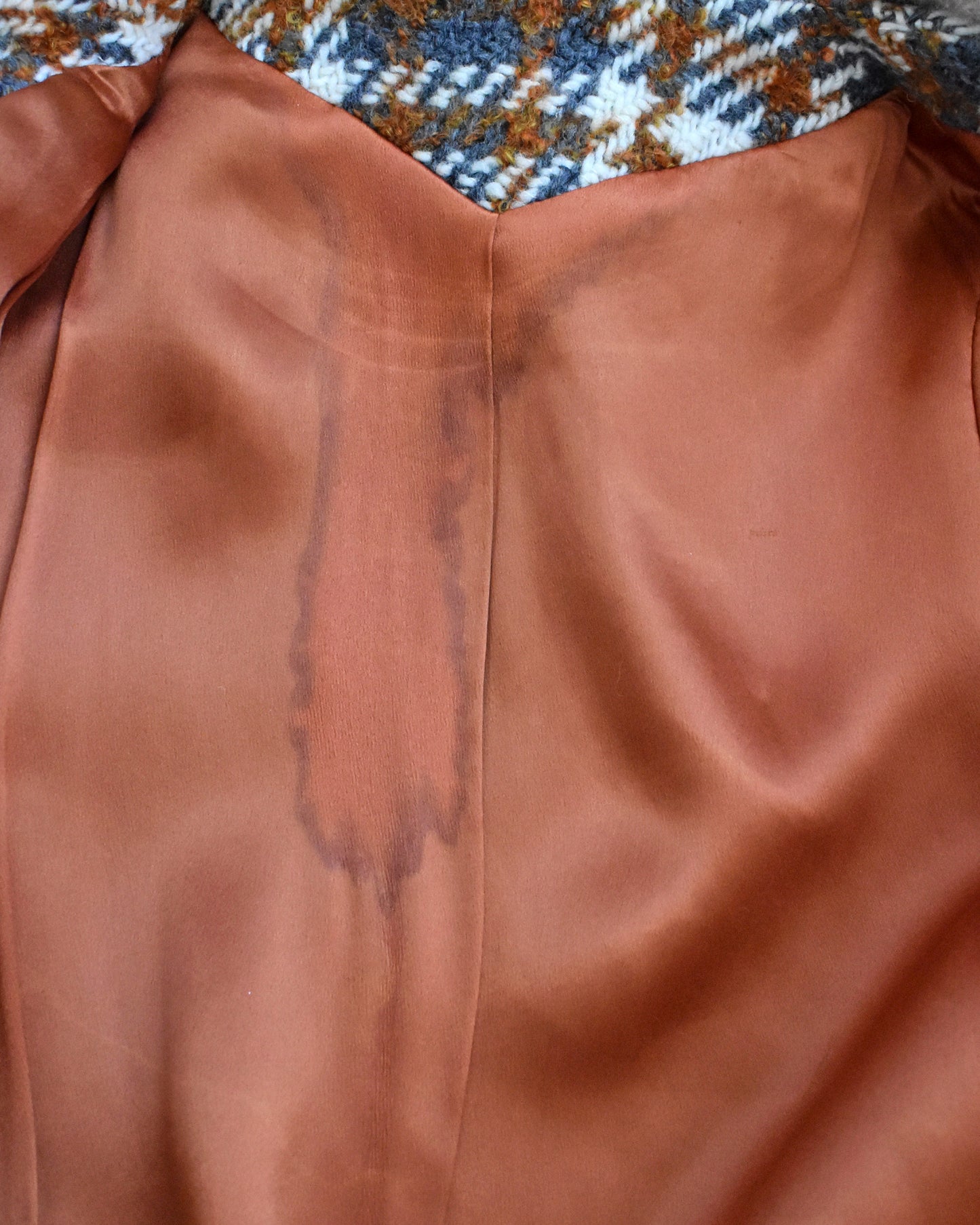 close up of the stain on the inside lining of the coat