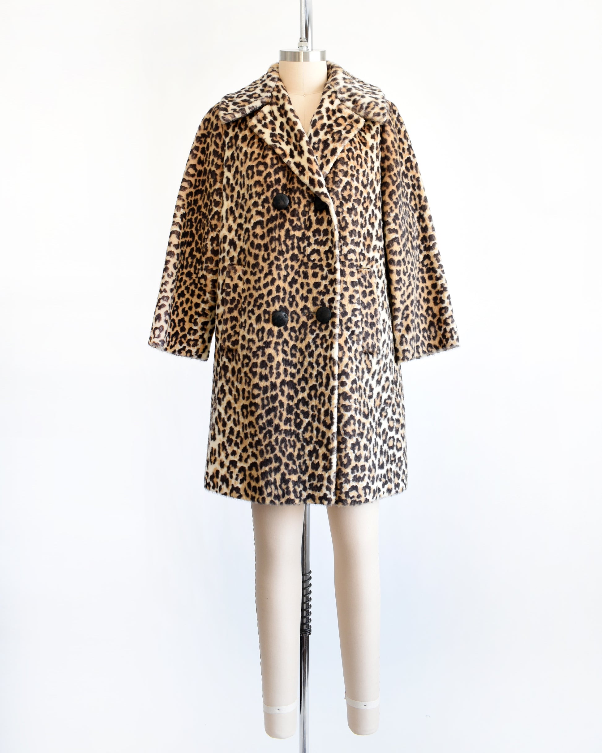 a vintage late 1960s early 1970s faux fur leopard print coat with four black buttons