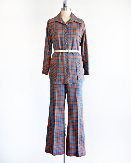 A vintage 1970s blue and orange plaid pantsuit. This set includes a blue and orange plaid long sleeve blouse and matching wide leg pants. There is a white belt shown in this photo, but not included.