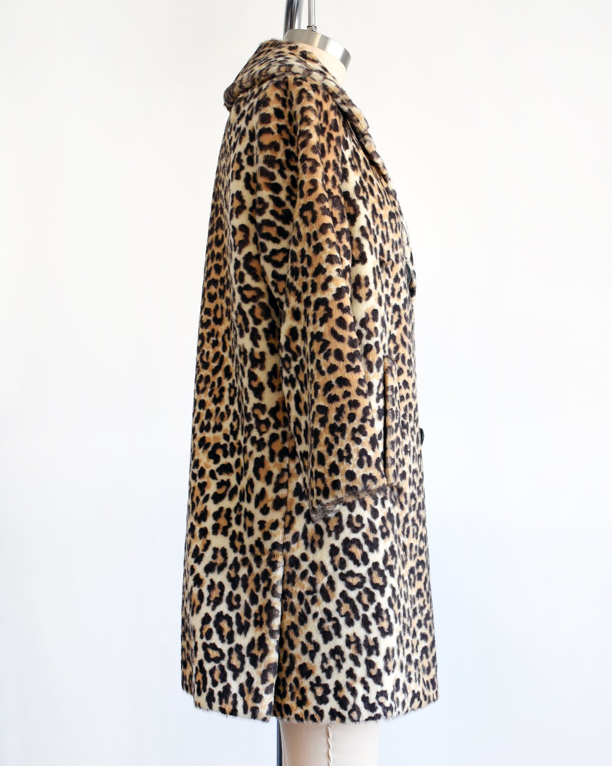 side view of a vintage late 1960s early 1970s faux fur leopard print coat with four black buttons