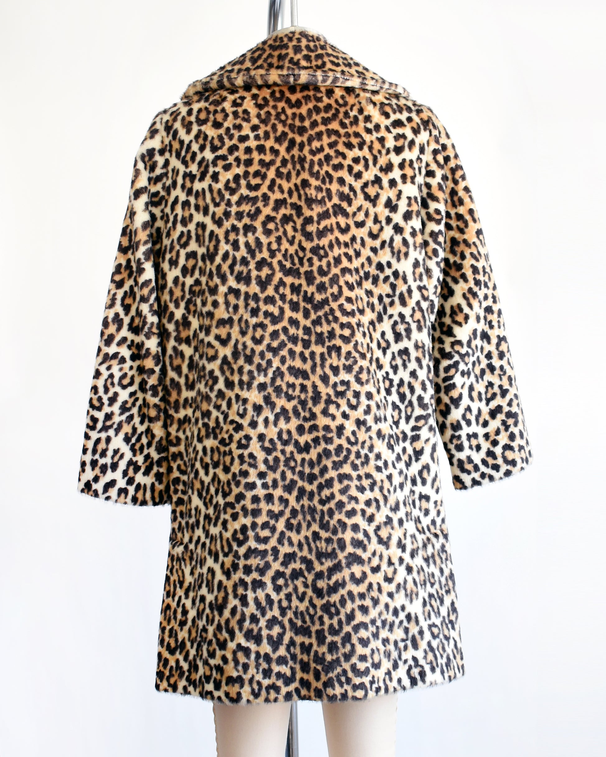 back view of a vintage late 1960s early 1970s faux fur leopard print coat 