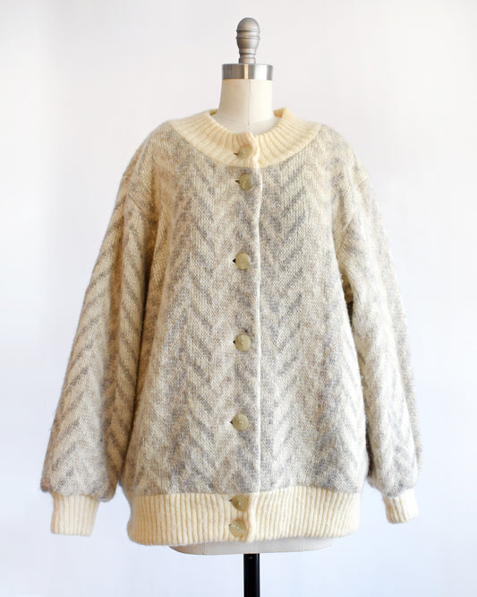 a vintage 1970s Icelandic knitted cardigan on a mannequin against a white background