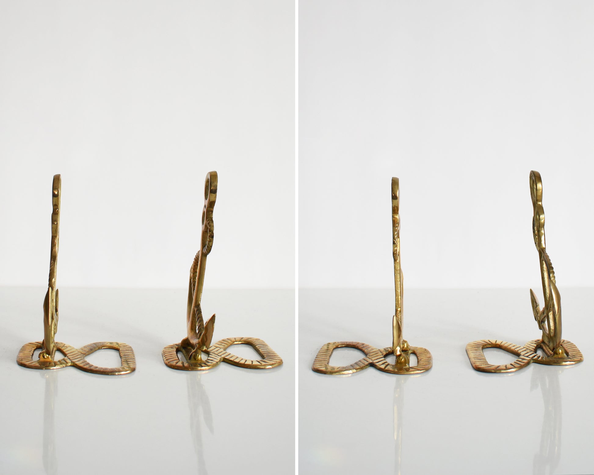 Side by side views of two vintage brass anchor and rope bookends.