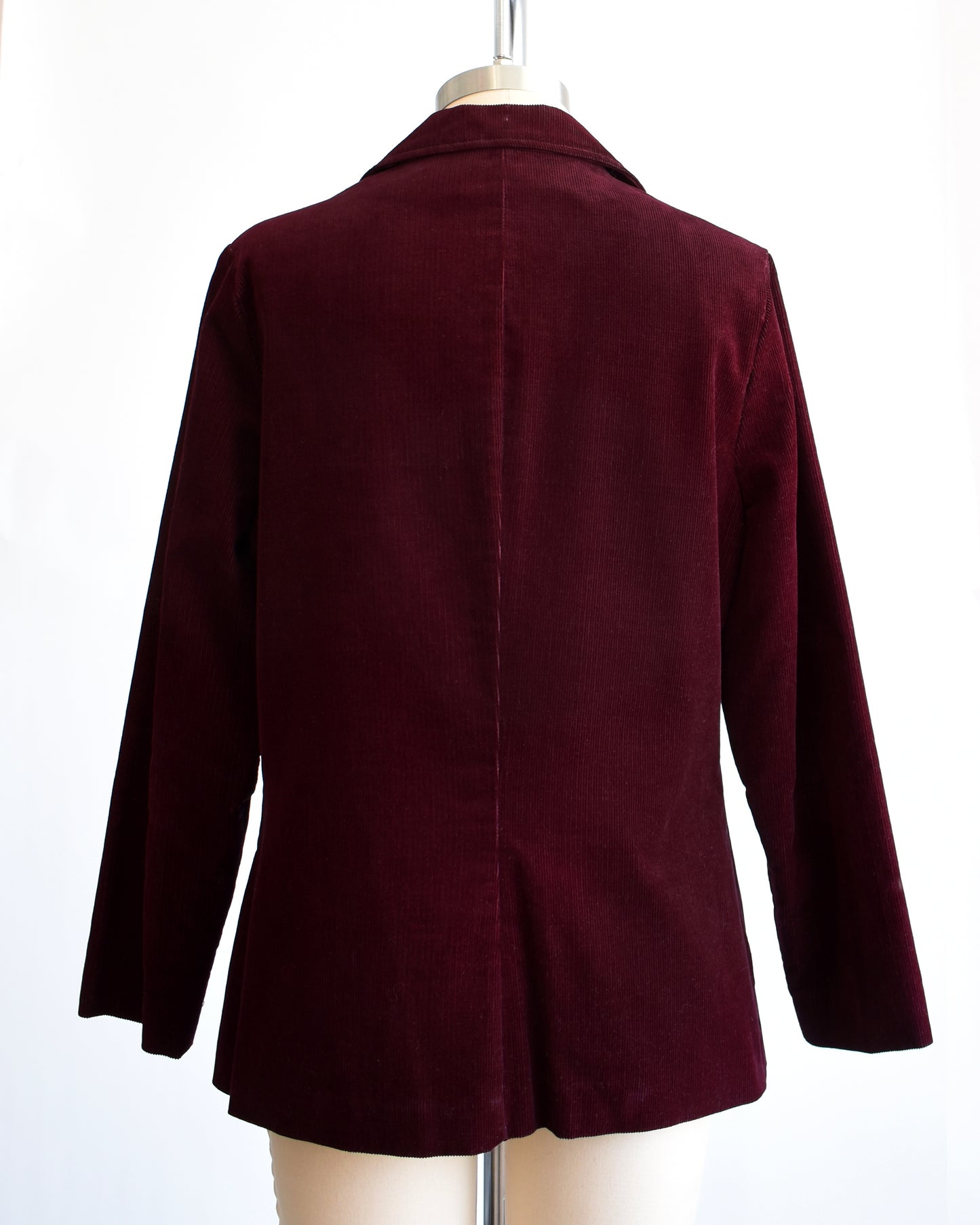 Back view of a vintage 1980s burgundy corduroy blazer