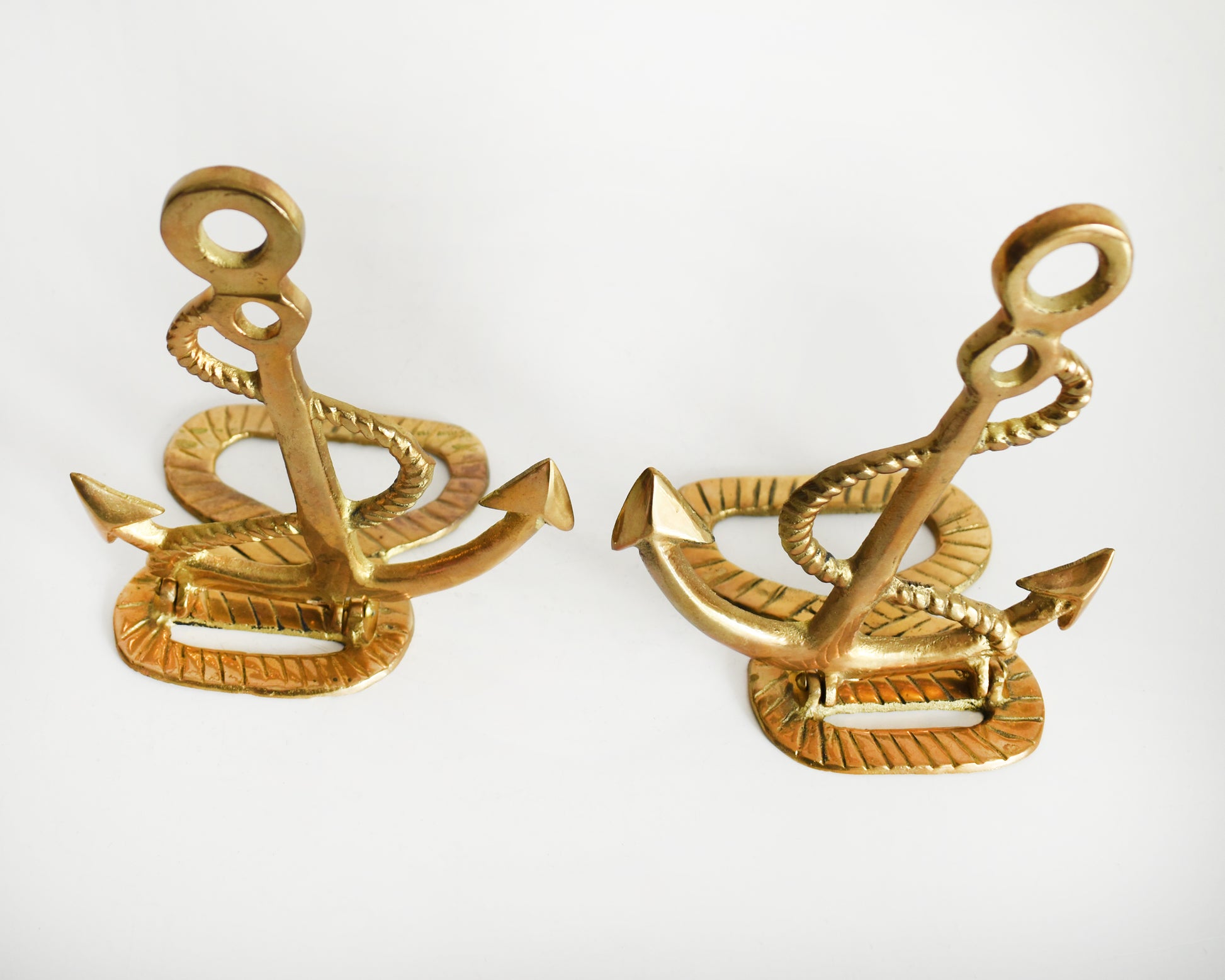 Overhead shot of two vintage brass anchor and rope bookends.