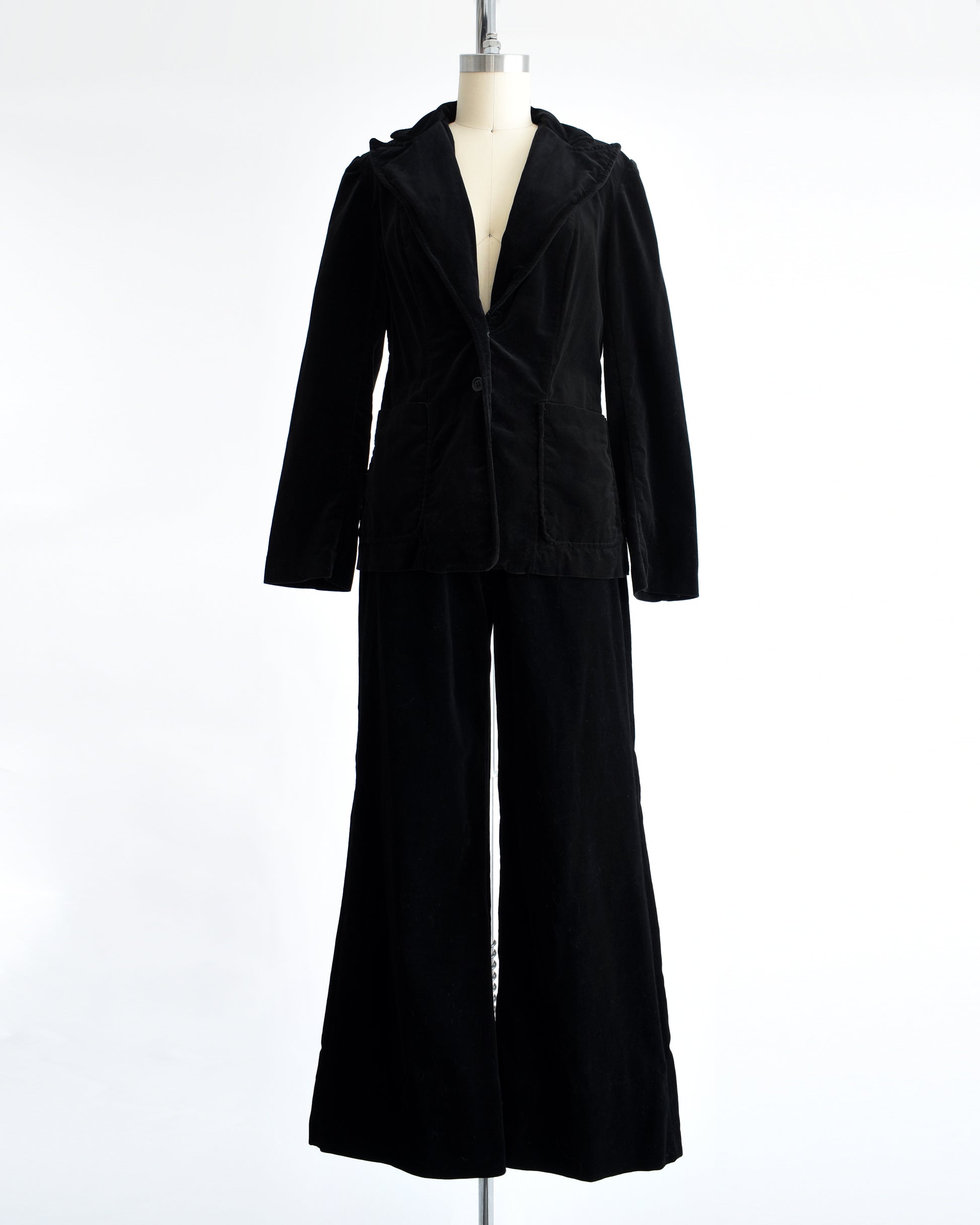 a vintage 1970s black velvet pant set on a mannequin against a white background