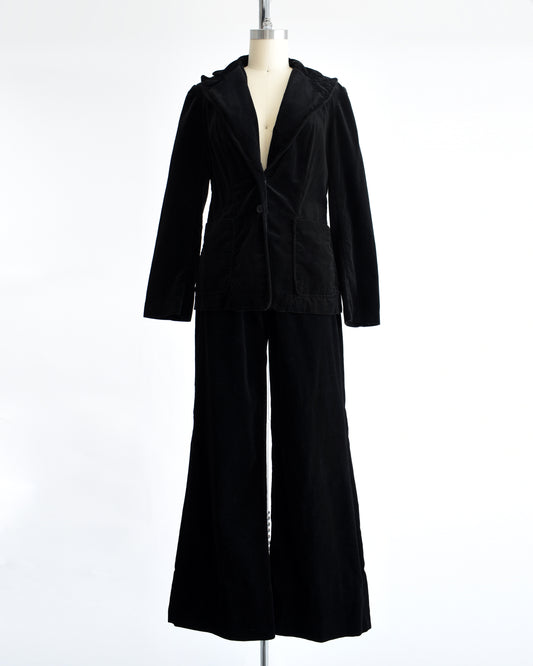 a vintage 1970s black velvet pant set on a mannequin against a white background