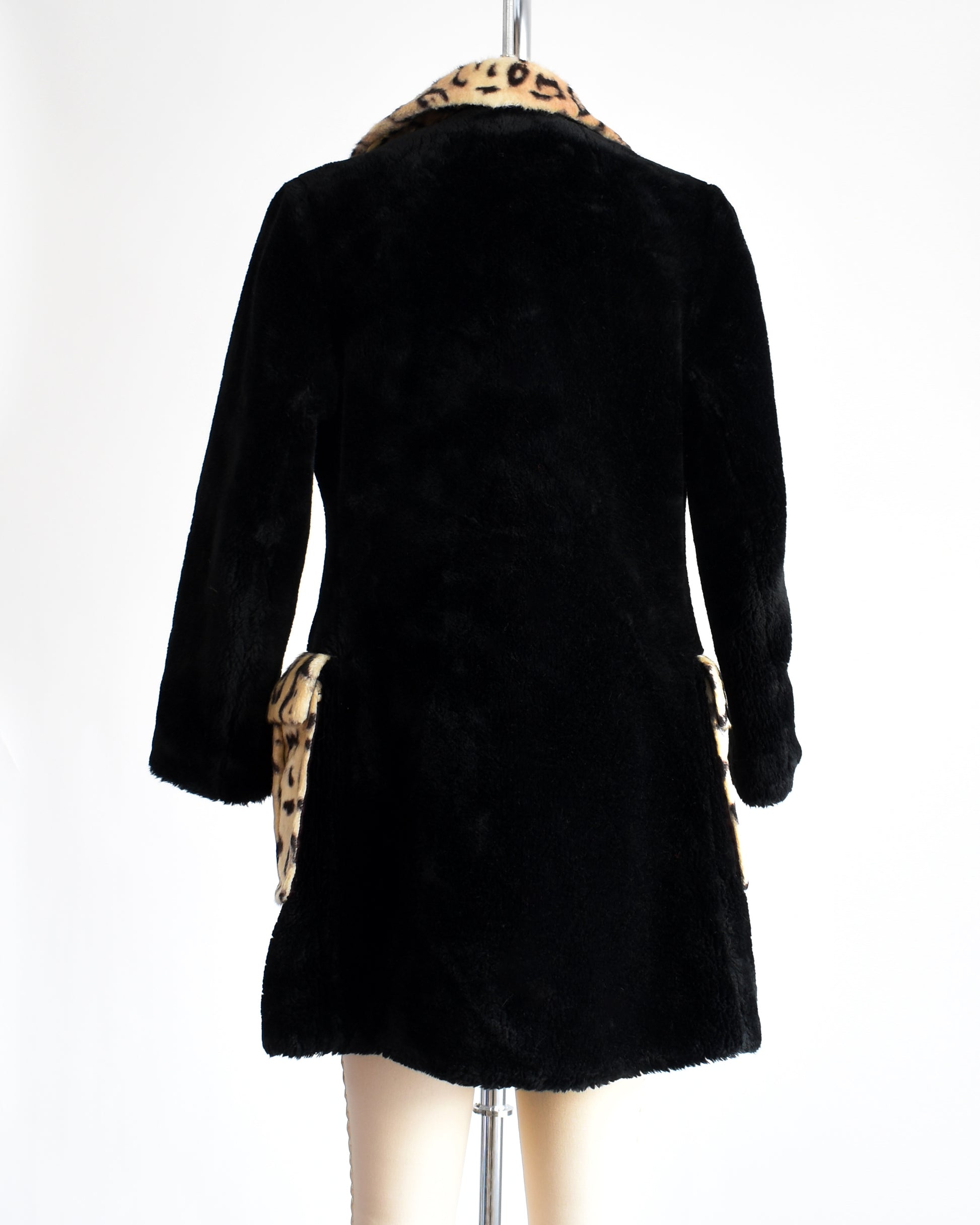 Back view of a vintage leopard print coat that is black on the back