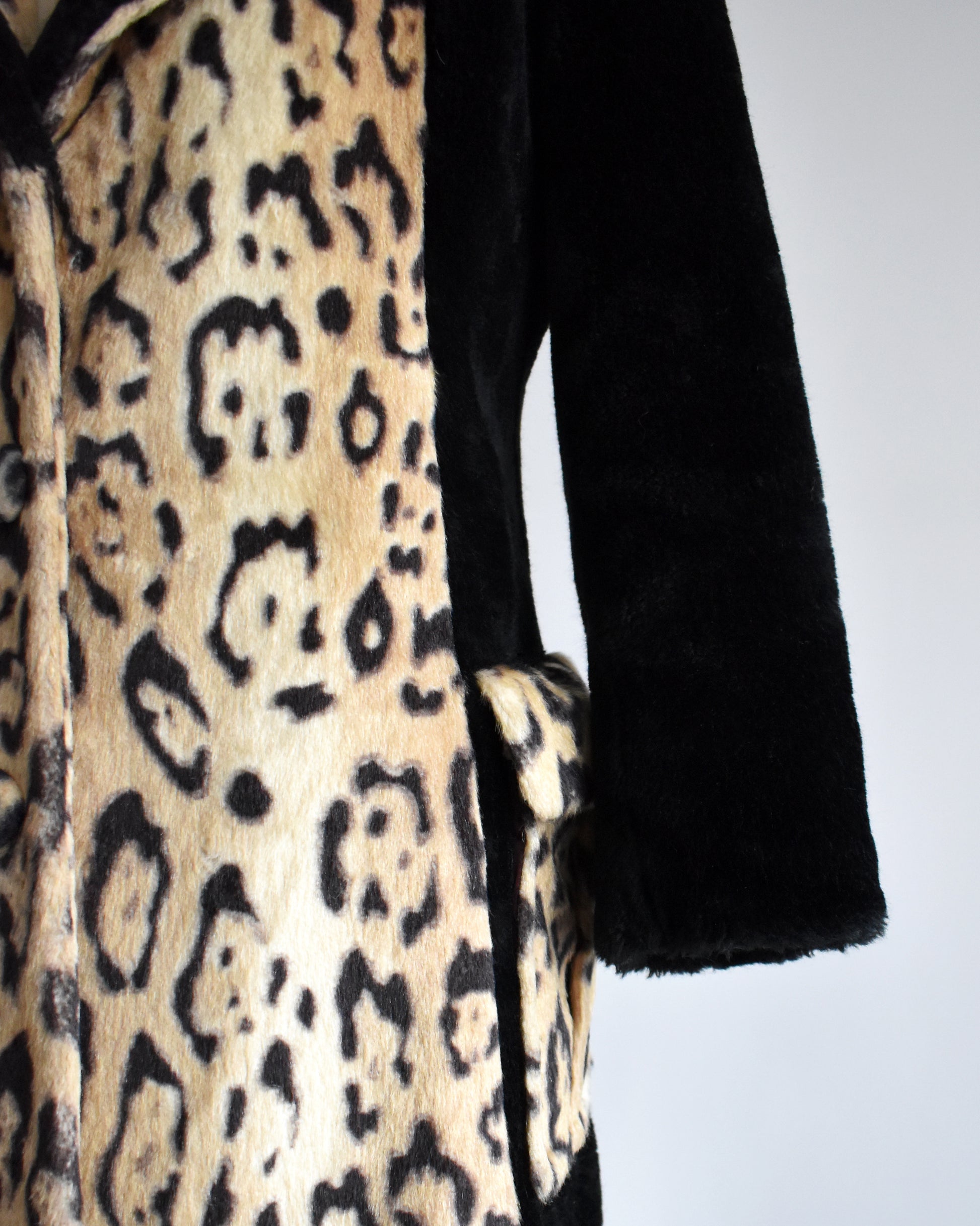 Close up of the sleeve, pocket, and leopard print front.