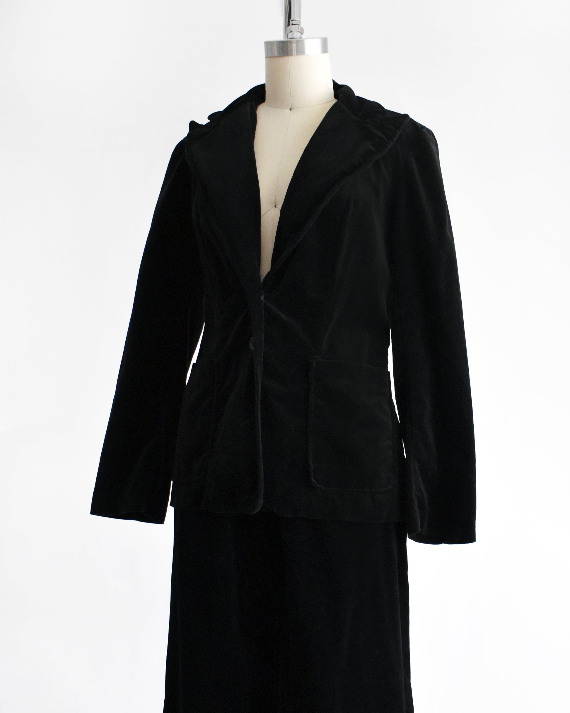 side front view of a vintage 1970s black velvet pant set on a mannequin against a white background
