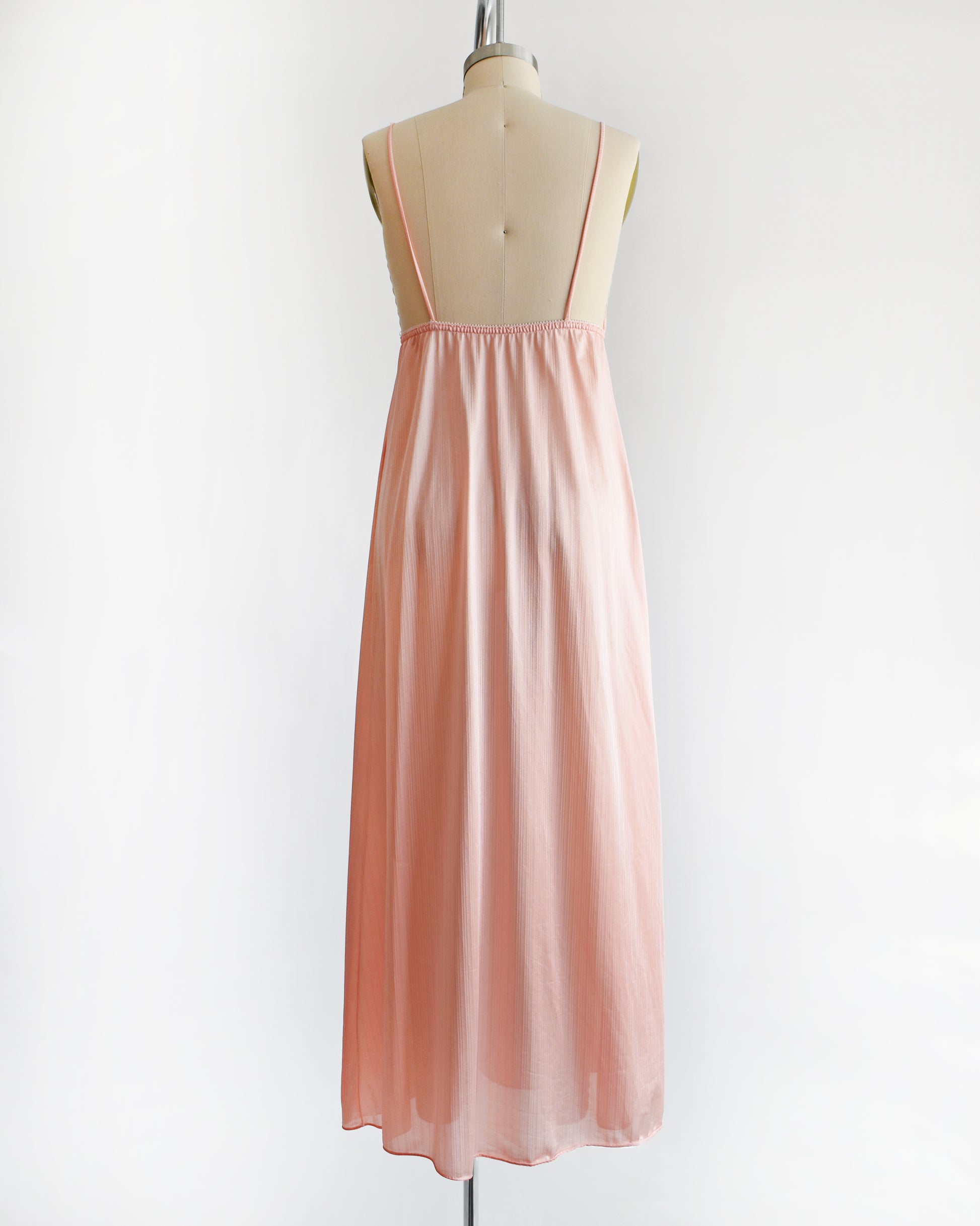 Back view of a A vintage 1970s peachy pink nightgown 