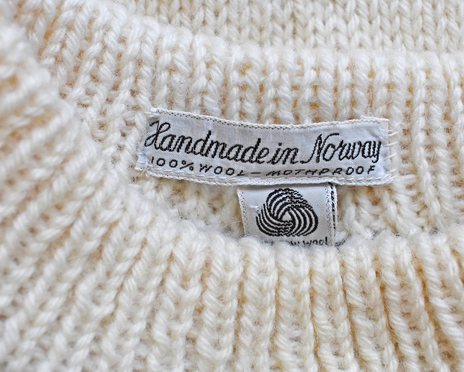 Close up of the tag which says "Handmade in Norway, 100% Wool - Mothproof"