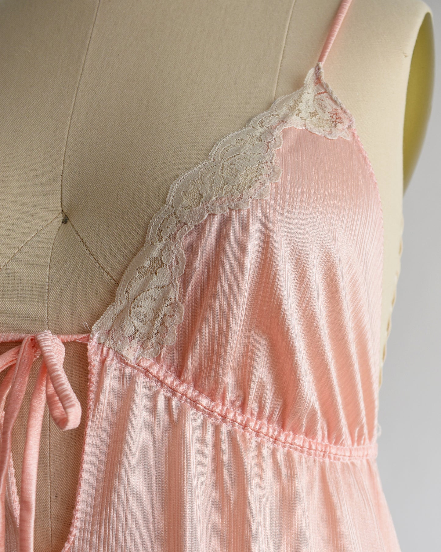 Close up of the bodice which shows the lace trim and texture of the fabric