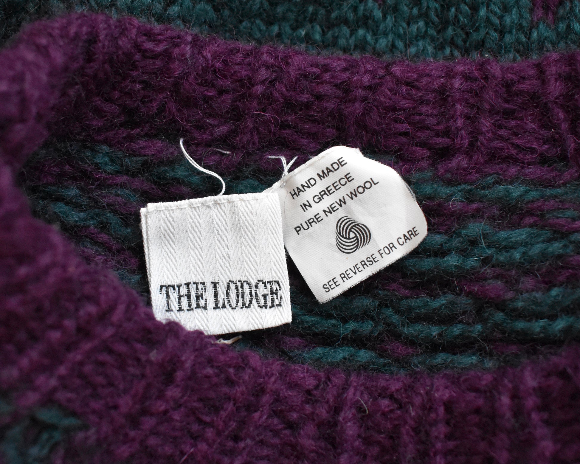 Close up of the tag which says The Lodge and Hand made in Greece Pure New Wool