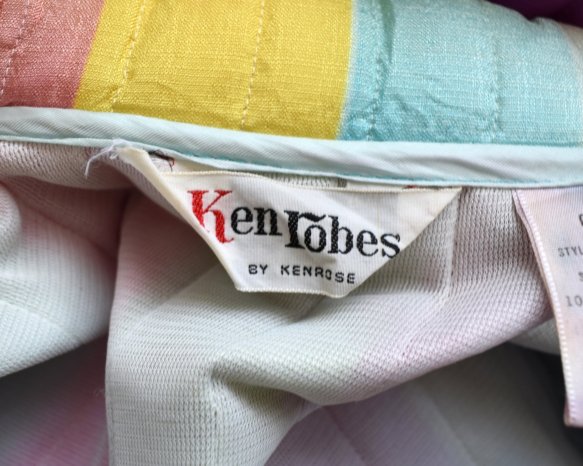 Close up of the tag that says Ken Robes by Ken Rose