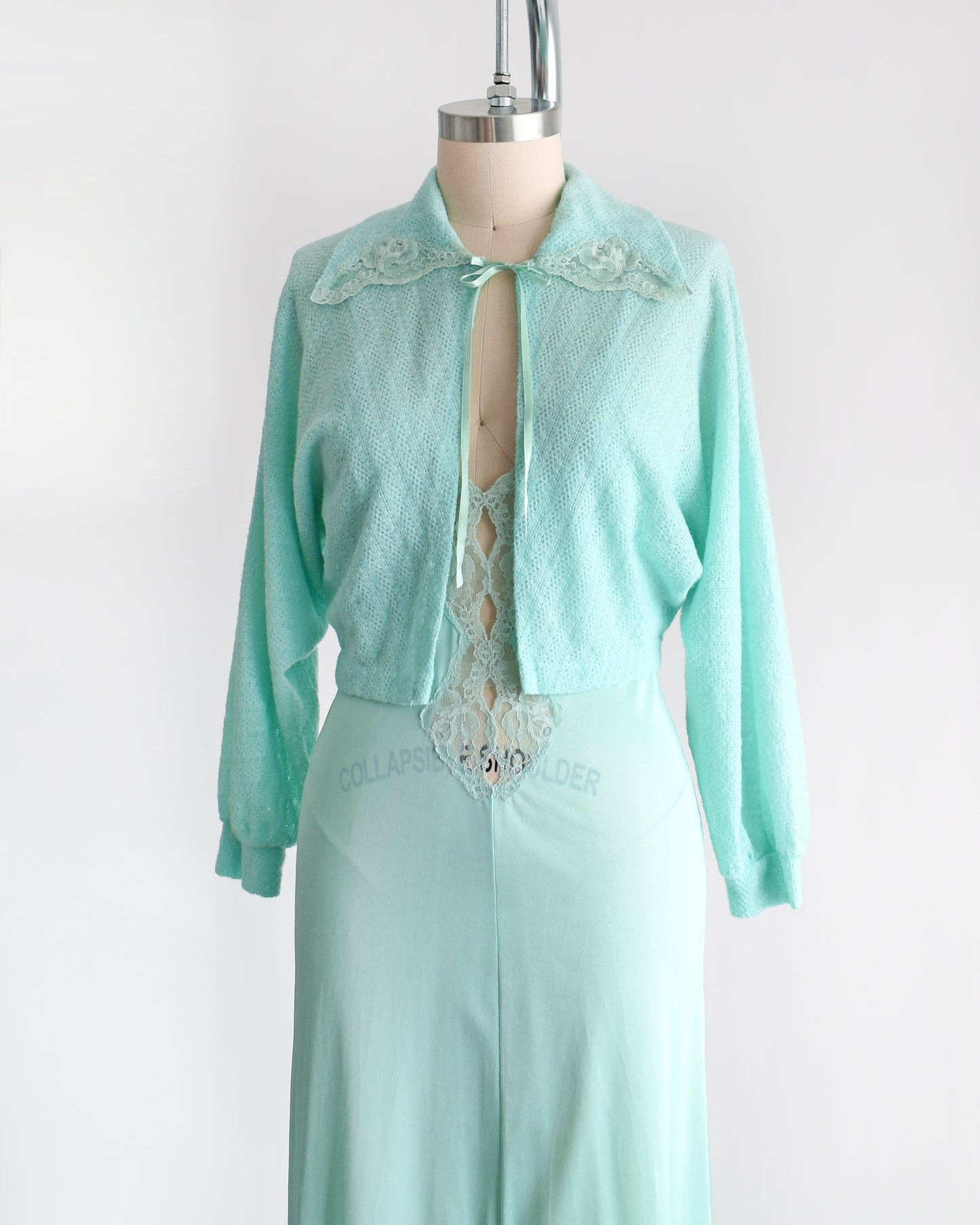 Side front view of a vintage 1970s mint green nightgown and bed jacket set. 