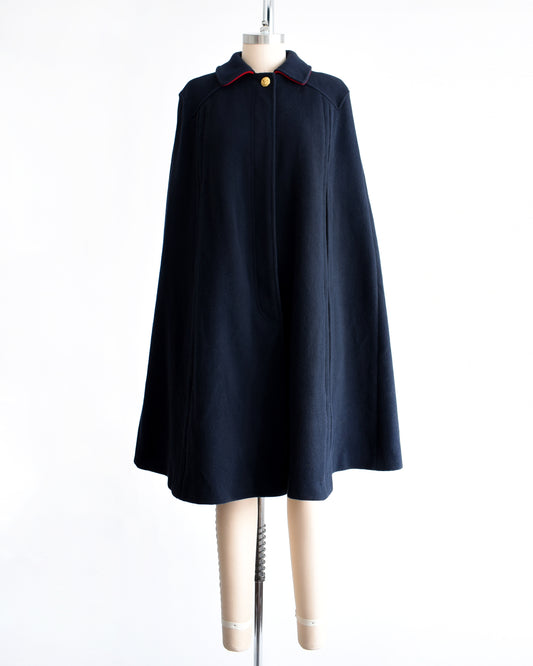 a vintage 1970s navy blue cape on a mannequin against a white background