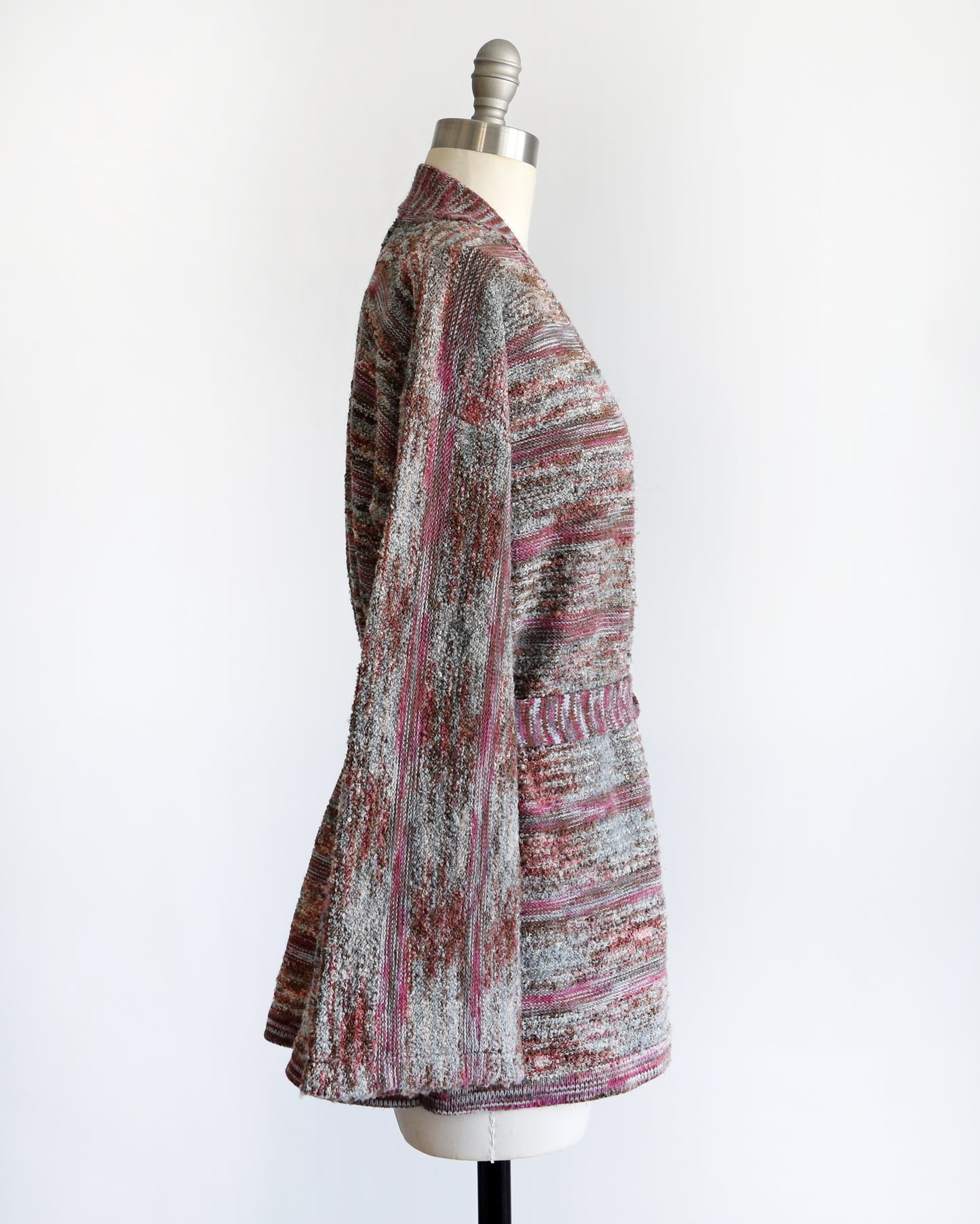 side view of a vintage 1970s space dye wrap cardigan on a dress form against a white background