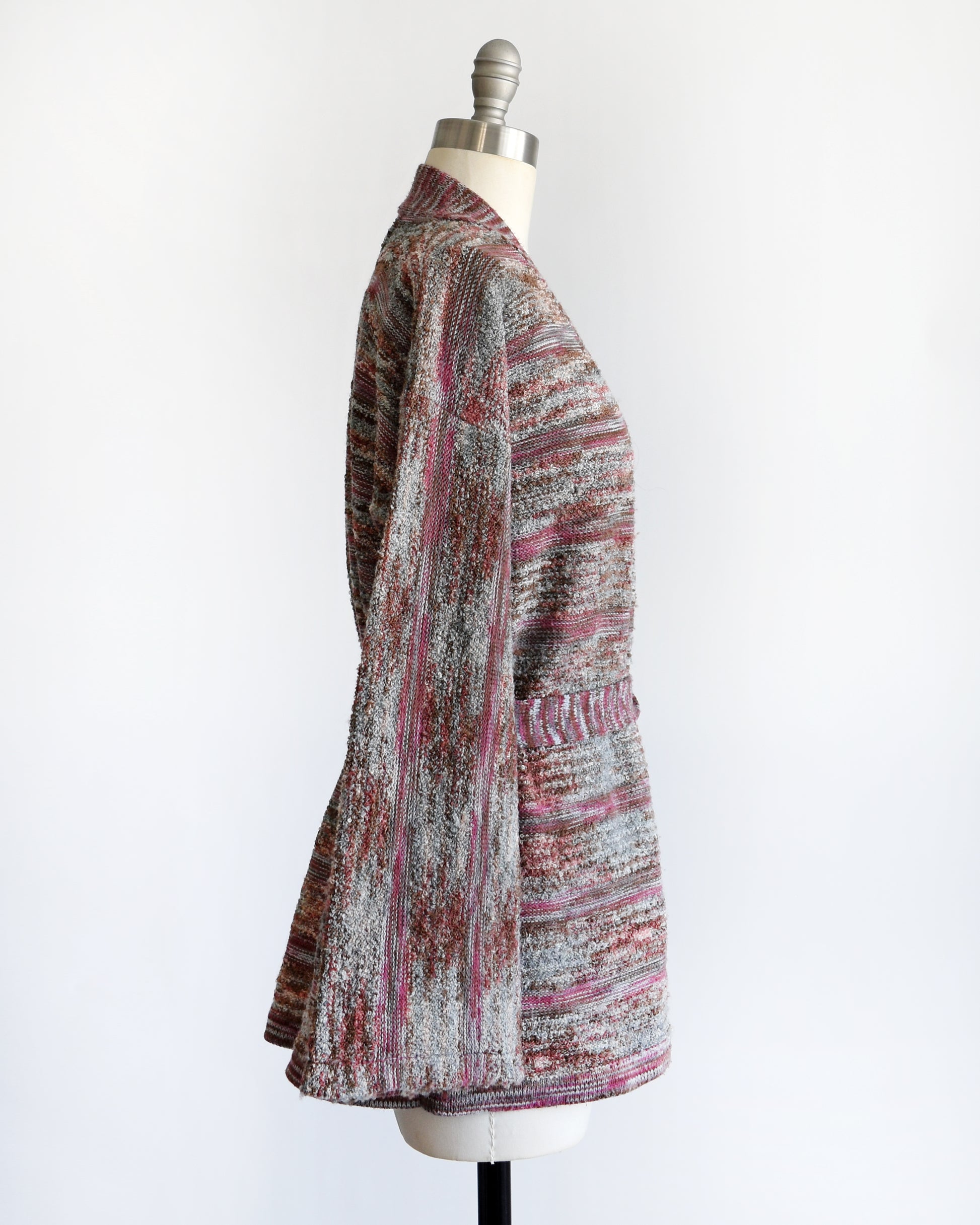 side view of a vintage 1970s space dye wrap cardigan on a dress form against a white background