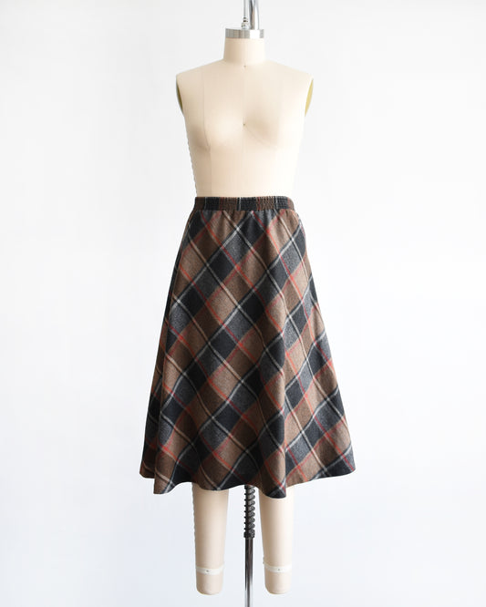 a vintage 1980s plaid skirt on a mannequin against a white background