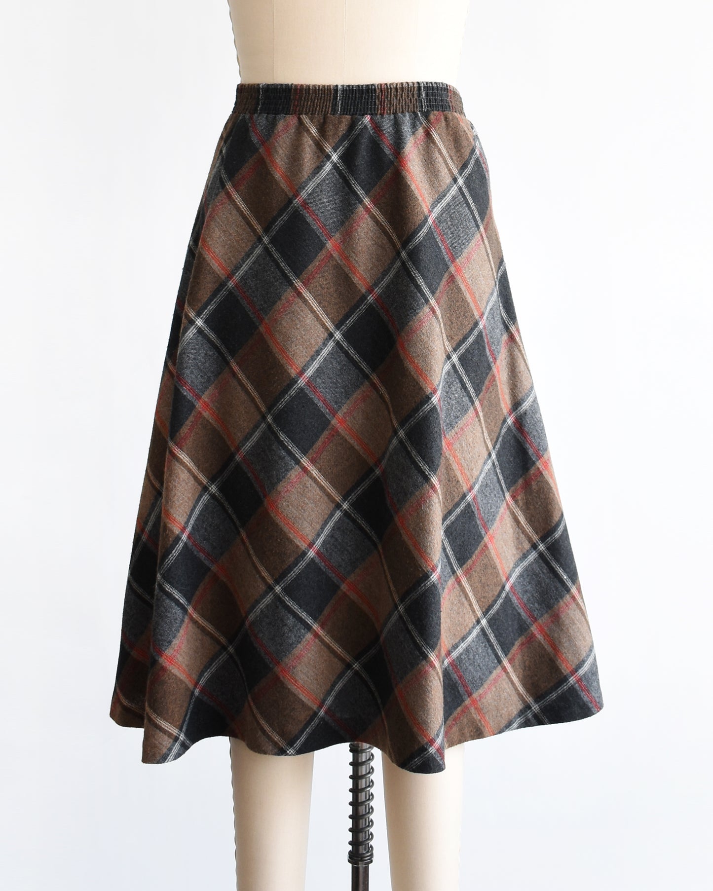 a vintage 1980s plaid skirt on a mannequin against a white background