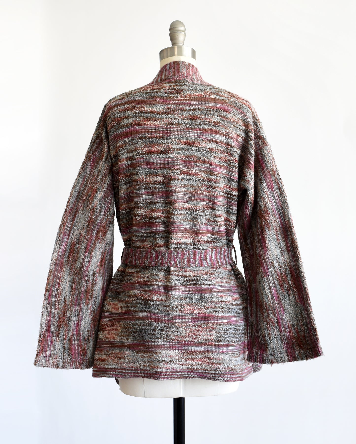 back view of a vintage 1970s space dye wrap cardigan on a dress form against a white background